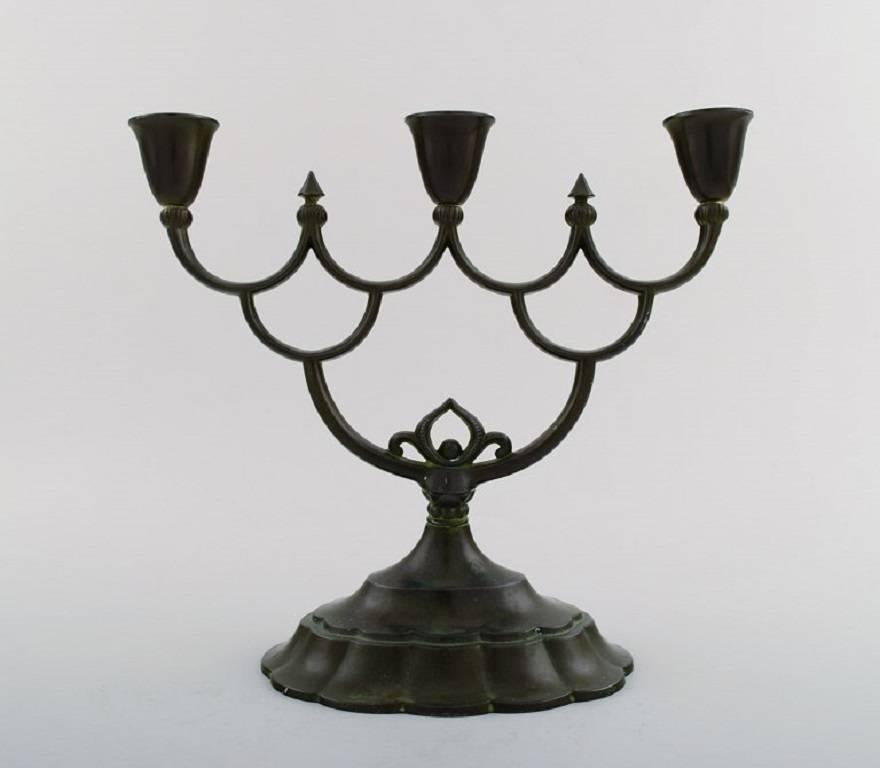 Just Andersen, early three-armed candlestick of patinated 