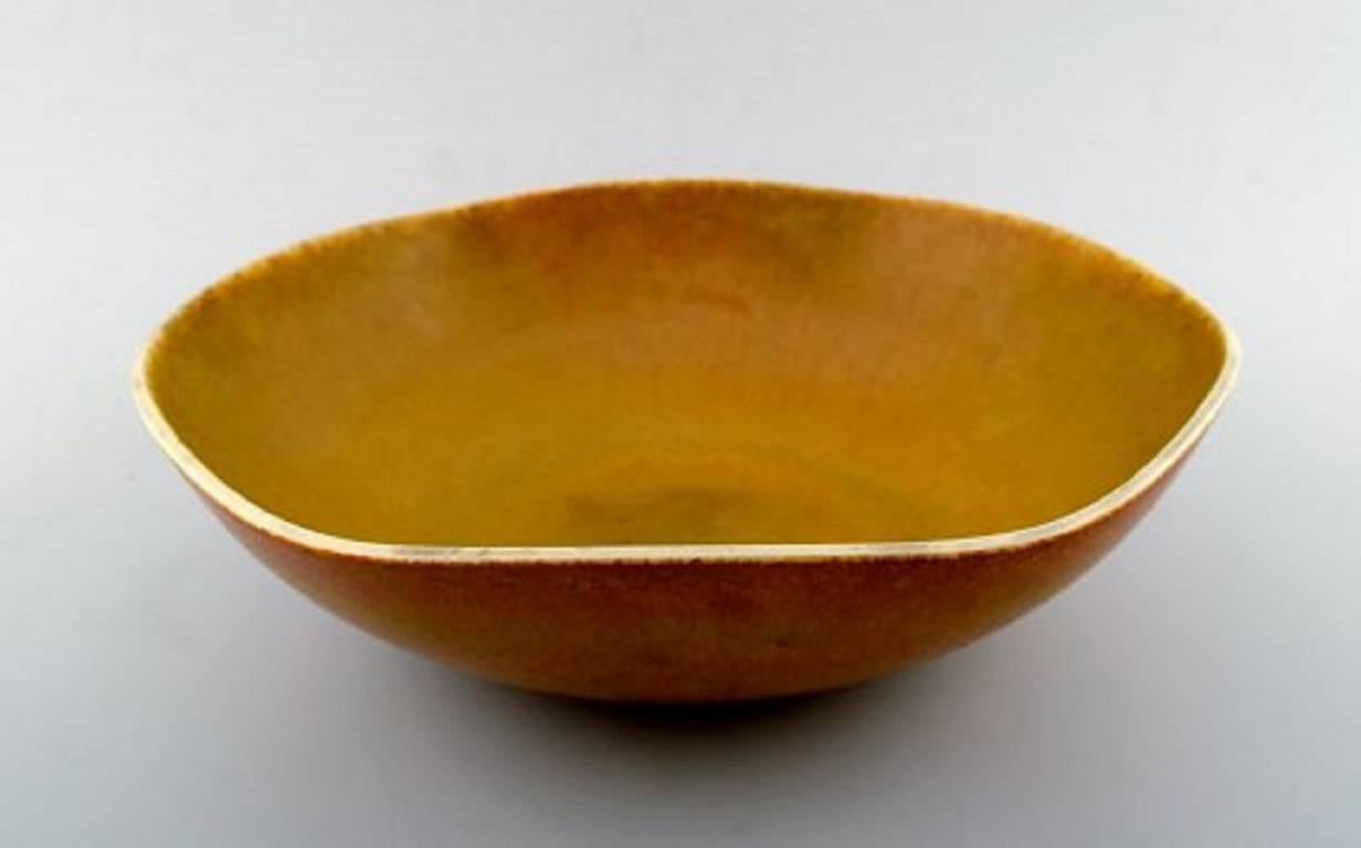 Berndt Friberg Studio large ceramic bowl. 
Modern Swedish design. Unique, handmade.
Fantastic solfatara glaze in yellow shades!
Perfect. 1st. factory quality. Signed. Year F = 1964.
Measures: 31 cm. x 9.5 cm.