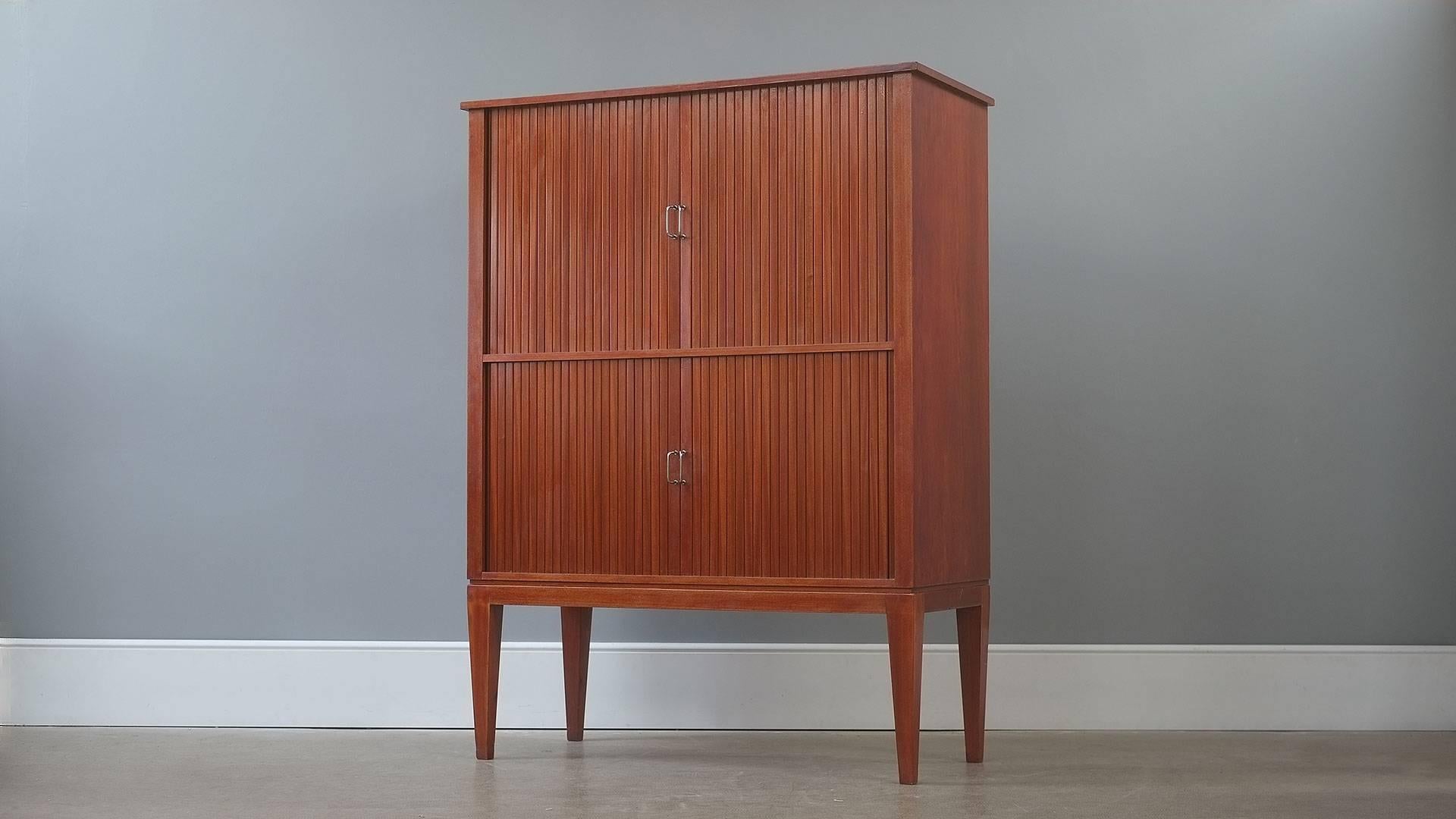 Truly spectacular 1940s Danish collectors cabinet in mahogany with tambour doors. Specially commissioned piece with 50 internal drawers by an unknown Danish cabinet maker. Ultra elegant proportions and superb quality one of a kind piece.