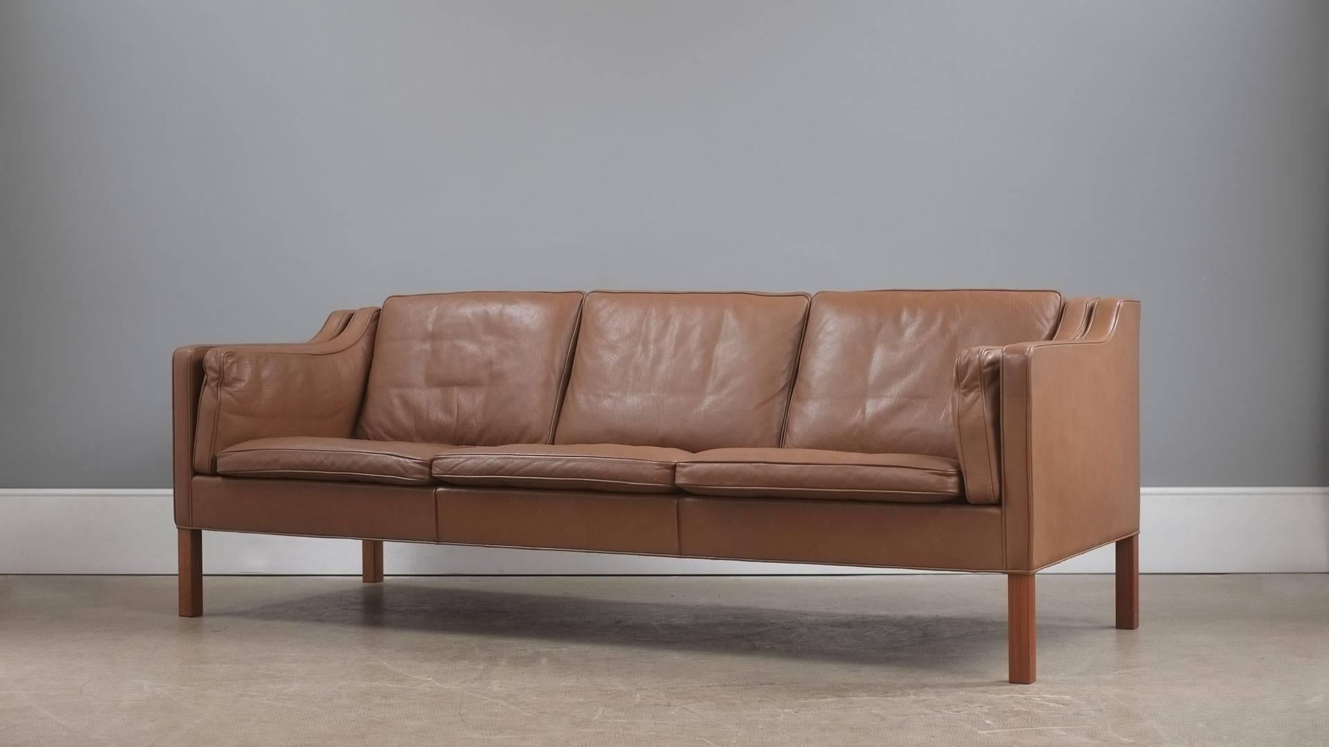 The real thing fantastic example of the Classic three seat sofa designed by Børge Mogensen for Fredericia, Denmark model 2213. Unsurpassed quality and in beautiful light brown leather with solid teak legs. Wonderful example.