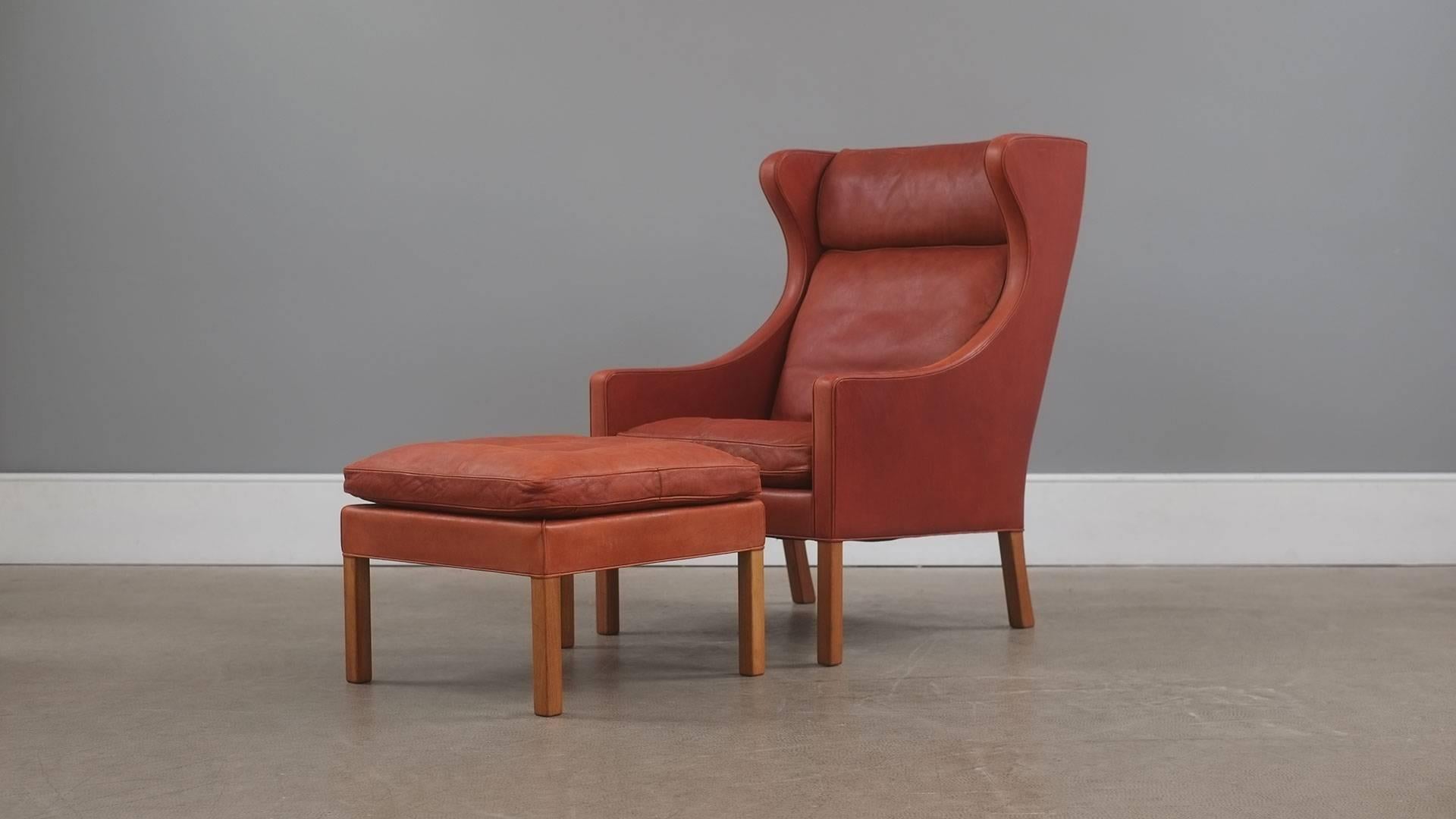 Amazing example of Borge Mogensen’s classic 2204 high back armchair and 2202 footstool for Fredericia, Denmark. This early chair and stool is in wonderful and super rare thick cognac analine leather with perfect patina. Originally purchased in 1971.