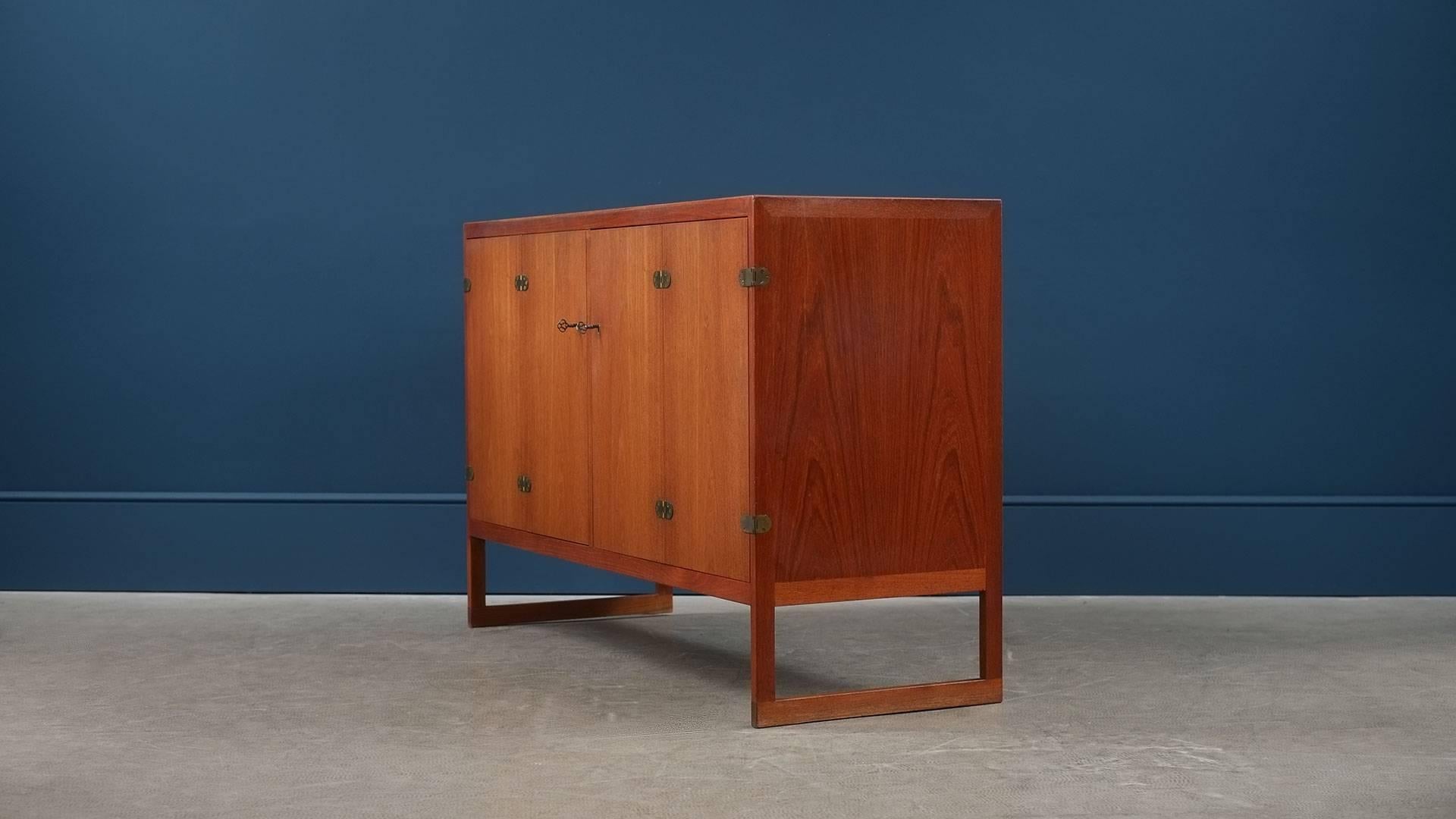 Rare and beautiful cabinet/sideboard in teak with brass details designed by Børge Mogensen for P. Lauritsen & Søn, 1957, Denmark. This example with contrasting oak interior. Wonderful piece, superb quality and ultra elegant.