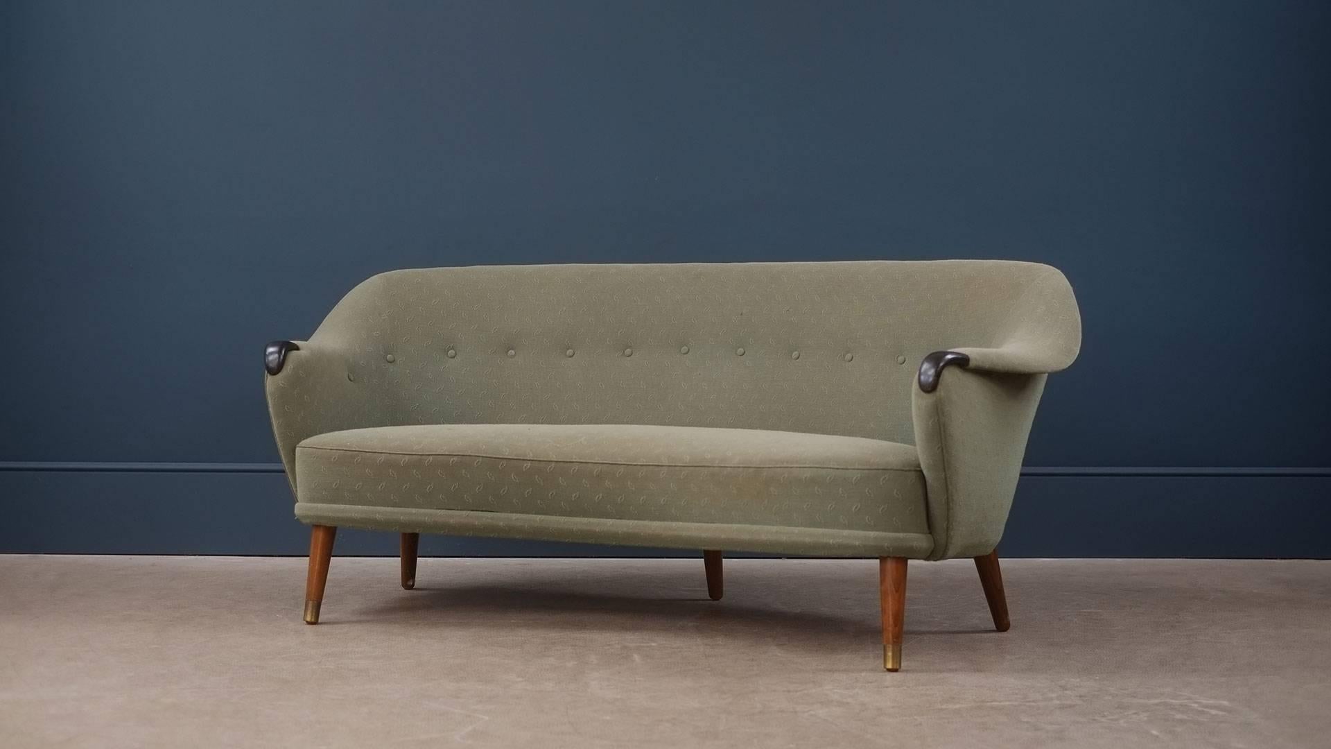 Staggering and ultra rare sofa designed by architect Arne Hovmand Olsen for cabinet maker Pedersen and Knap, Denmark, 1954. Amazing super sculptural sofa with fantastic detailing including original leather tips to the arms and brass sabots to the
