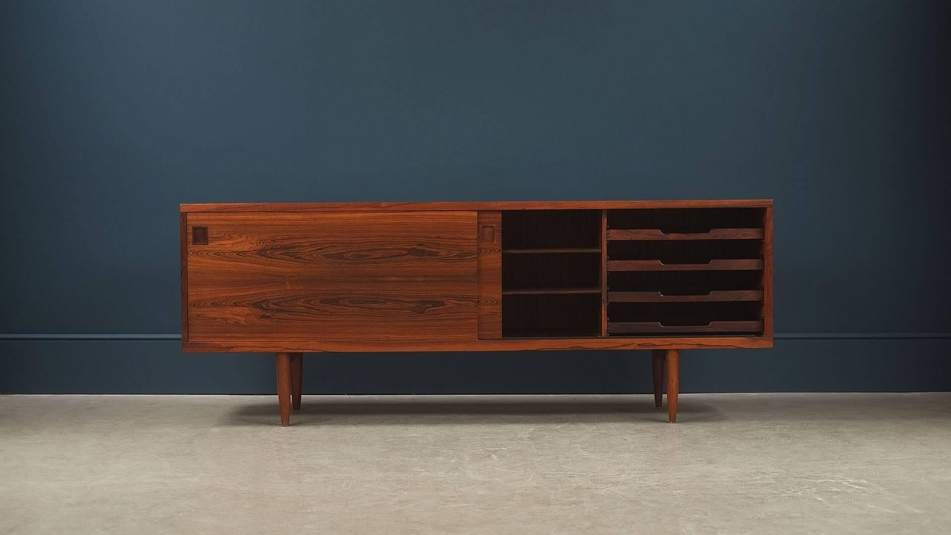 Super sought after and rare sideboard in wonderful rosewood with a staggering grain designed by Niels Moller, Denmark. Elegant proportions, simple detailing and ultra high quality piece.
 