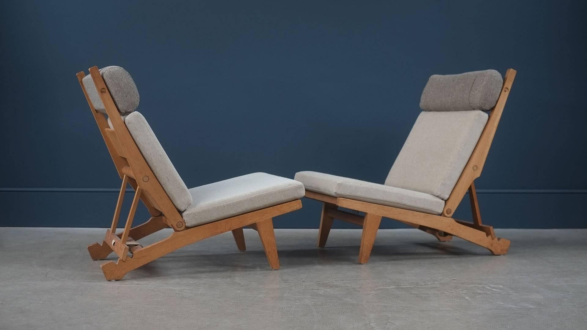 Rare and beautiful model AP71 reclining and folding chairs designed by Hans Wegner for cabinet makers AP Stolen, Denmark. Solid oak frame with flag Halyard seats. New cushions with Fleck . Super comfortable chairs and ultra high quality.
