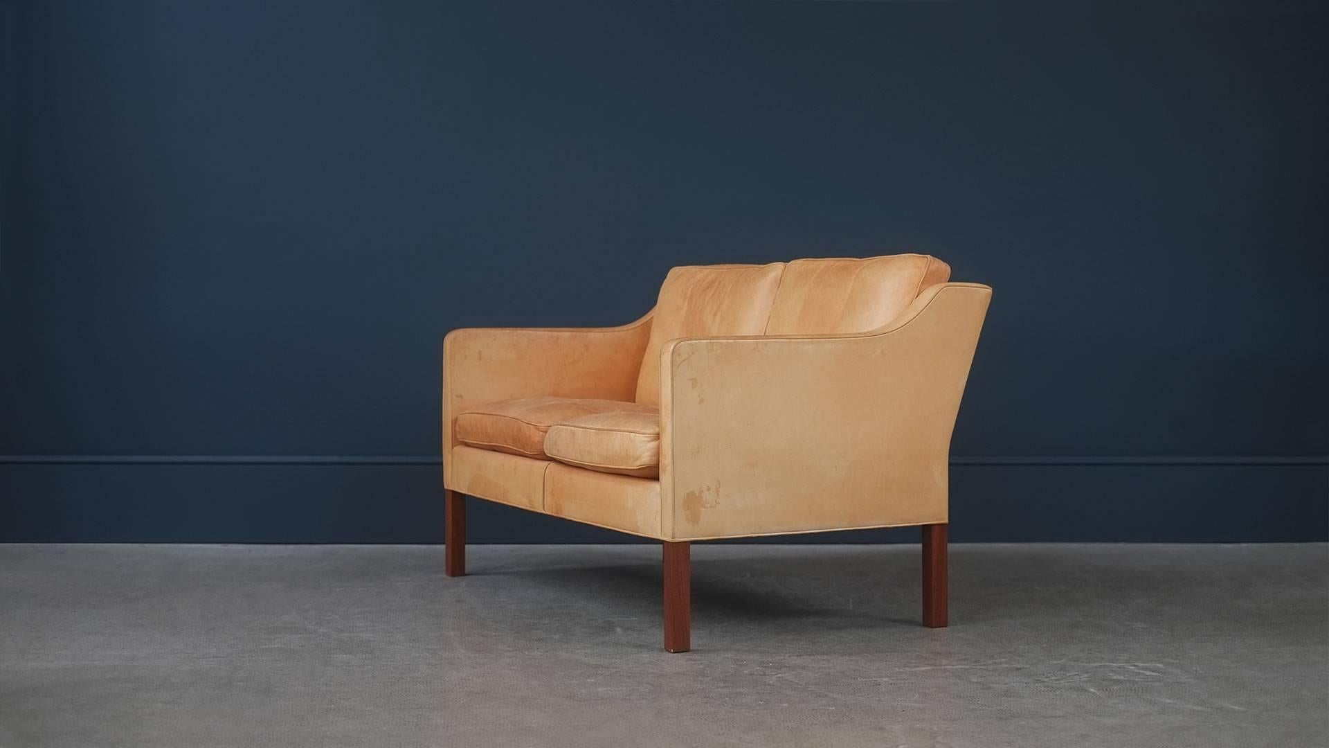 Amazing original sofa, model 2322, designed by Børge Mogensen for Fredericia Stolefabrik, Denmark. This example in rarer natural leather with wonderful patina and contrasting teak legs. Matching lounge chairs available. Superb.