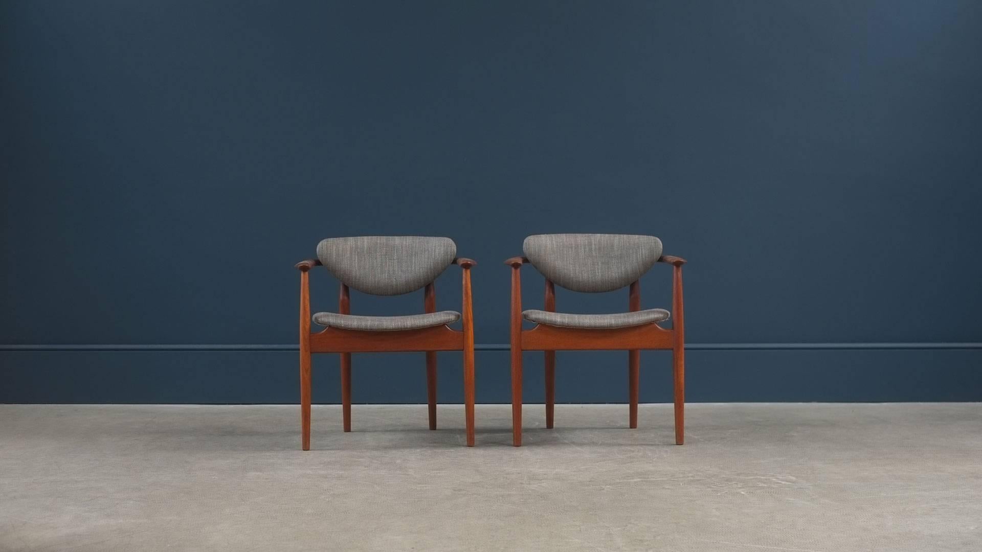 Beautiful and super rare armchairs designed by Finn Juhl for master cabinet maker Niels Vodder, Denmark, model NV55. Extremely sculptural armchairs in wonderful figured Burmese teak. Amazing pair of chairs.