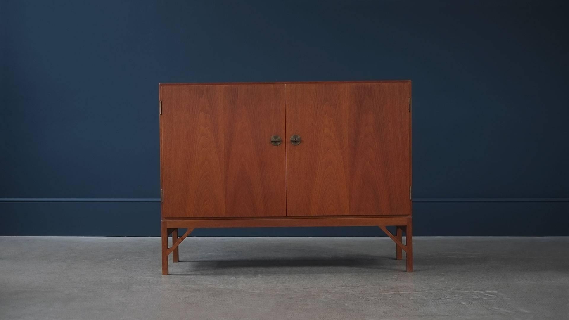 Wonderful cabinet in teak with contrasting interior in birch designed by Børge Mogensen for CM Madsen, Denmark. Super high quality and ultra-elegant with fantastic leg details and brass feature keys.