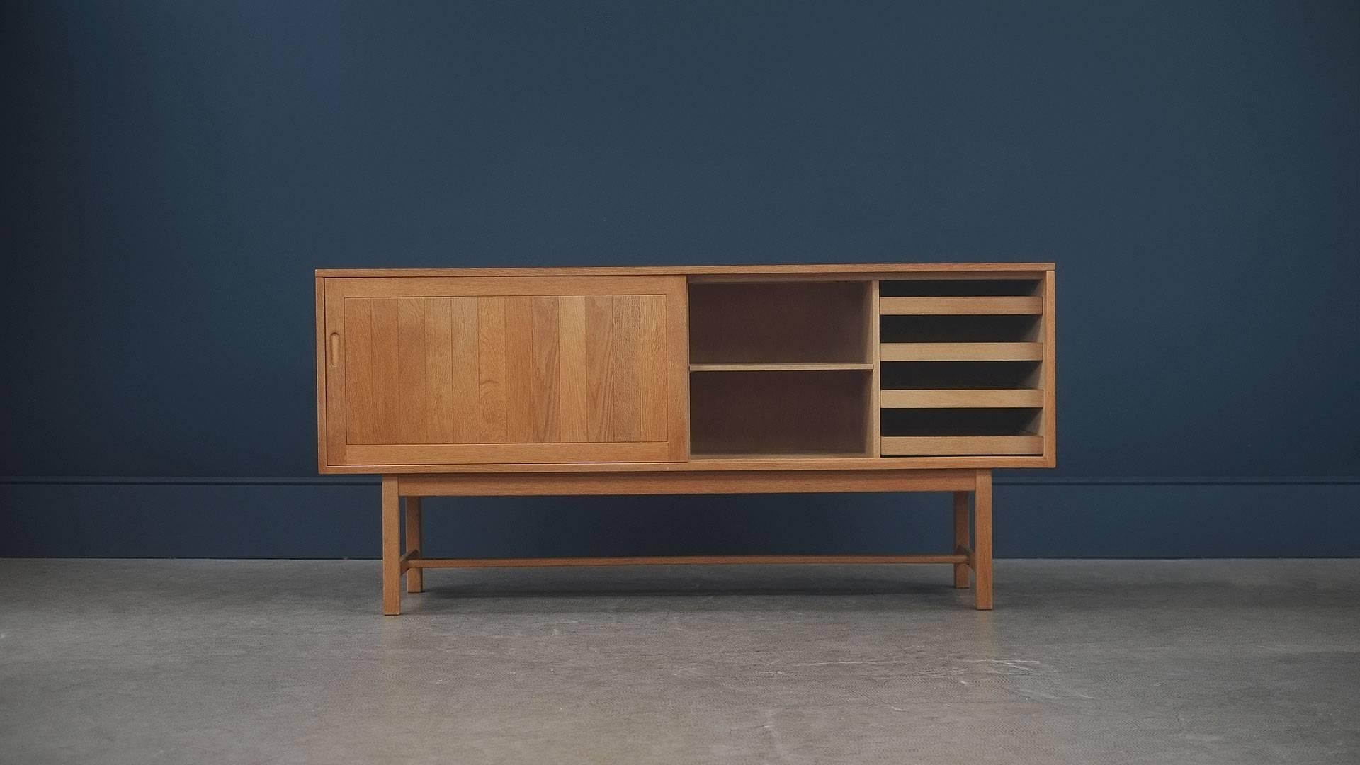 Beautiful sideboard in solid oak designed by Kurt Ostervig for KP Mobler, Denmark. Ultra high quality piece.