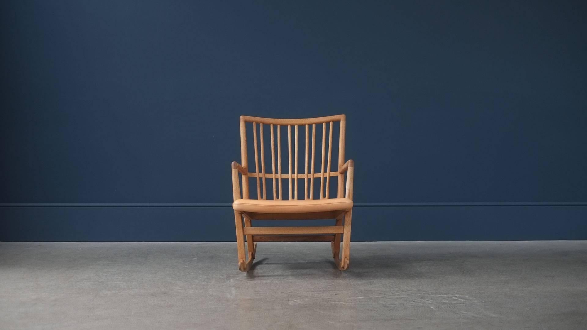Beautiful rocking chair model ML33 designed by Hans Wegner for Mikael Laursen, Denmark, 1942. Amazing quality solid oak frame with intricate back detail. This example with wonderful natural aniline leather seat with great patina. Seldom seen and
