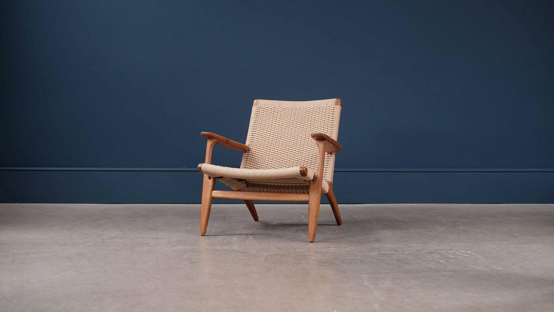 Beautiful original CH25 lounge chair in wonderful patinated oak with new papercord seat and back designed by Hans Wegner for Carl Hansen, Denmark. Great example.