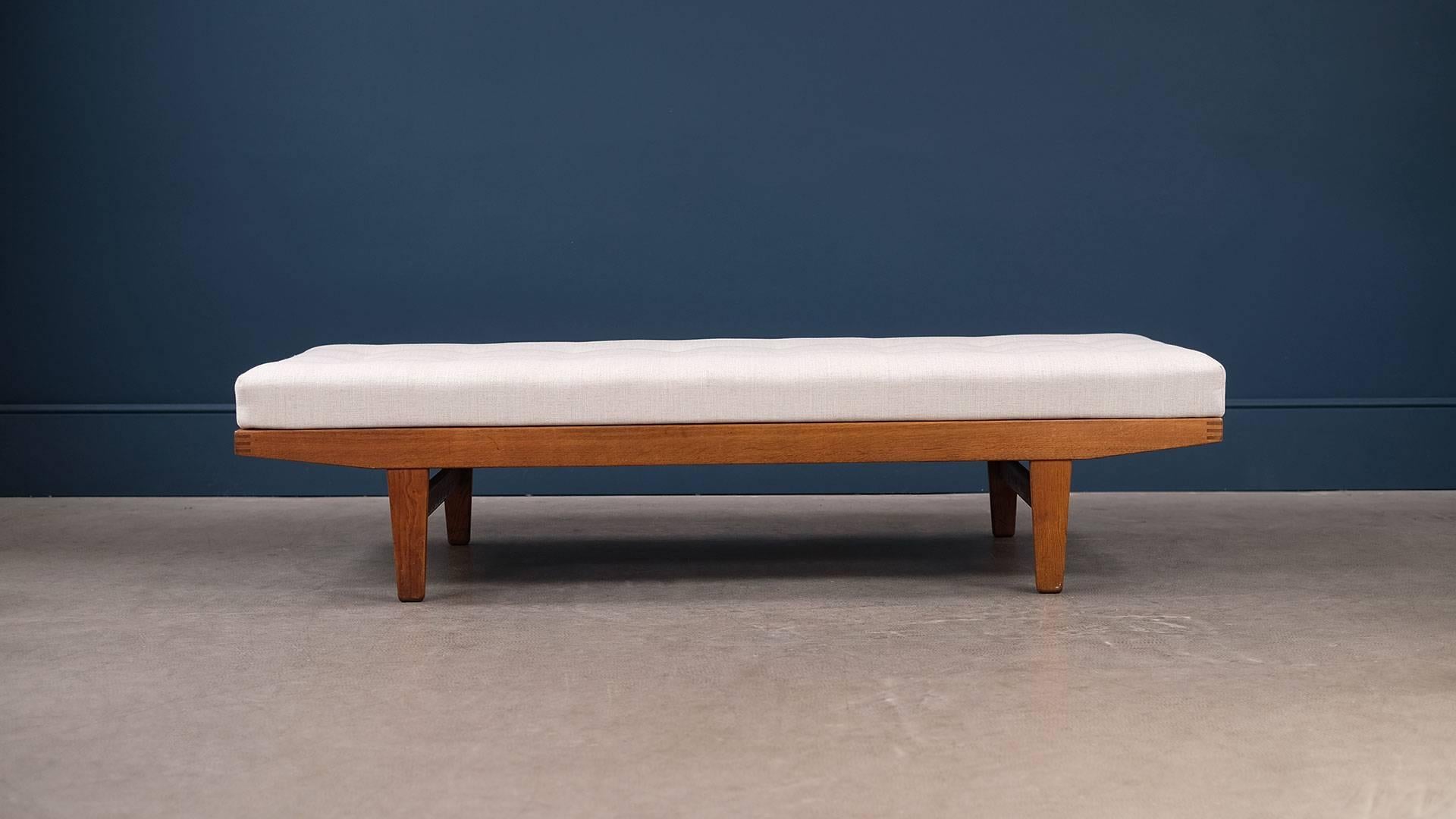 Beautiful Danish daybed in solid oak with wonderful exposed joint detail and exceptional patina. Designed and made for FDB, Denmark. Refurbished original fully sprung mattress with superb new upholstery.
     