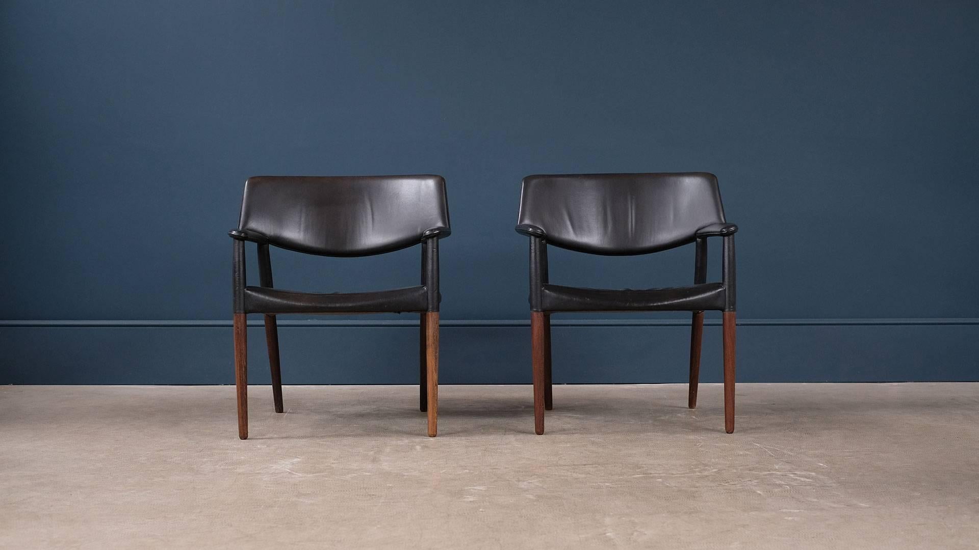 Monumental pair of chairs in solid wenge wood and original leather designed by architects Ejner Larsen & Aksel Bender Madsen and produced by master cabinetmaker Willy Beck, Denmark. Very elegant and grand chairs.