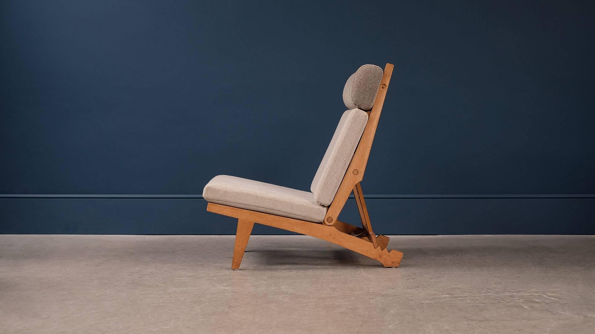 Rare and beautiful model AP 71 reclining and folding chair designed by Hans Wegner for cabinet makers AP Stolen, Denmark. Solid oak frame with flag Halyard seats and new cushions with Fleck fabric. Super comfortable chair and ultra high quality.