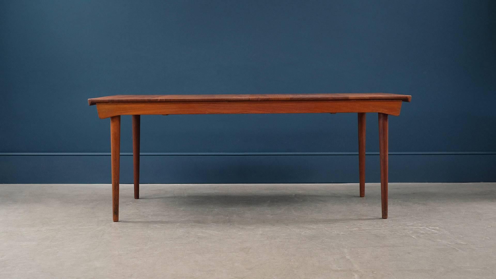 Wonderful large dining table with two leaves in richly patinated solid teak designed by Finn Juhl for France and Son, Denmark. Super high quality, stylish and practical Classic piece of Danish design.