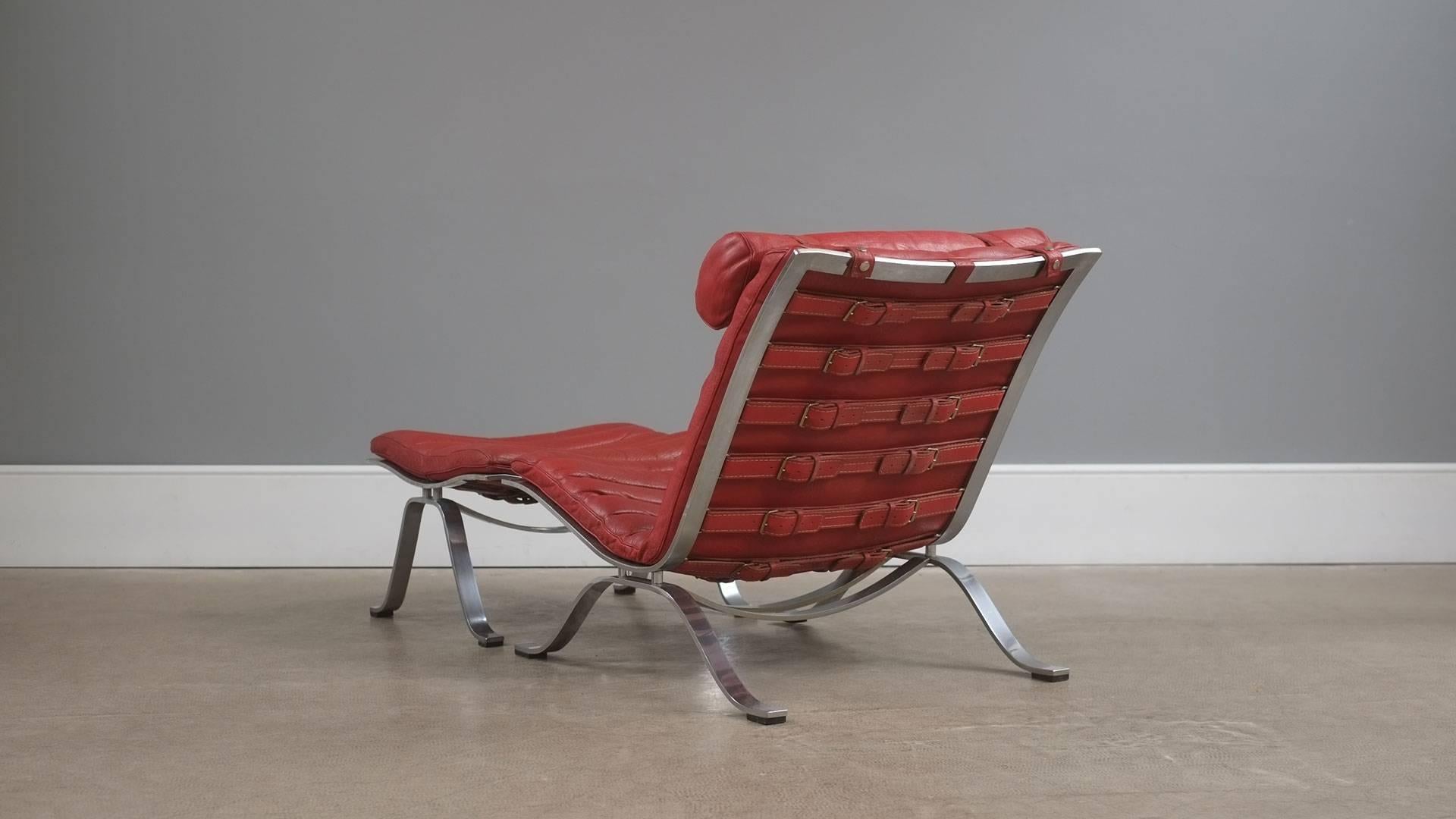 Amazing and rare Ari chair and ottoman in original red leather designed by Arne Norell for Norell furniture, Sweden. Exceptional quality, super stylish and very comfortable chair.