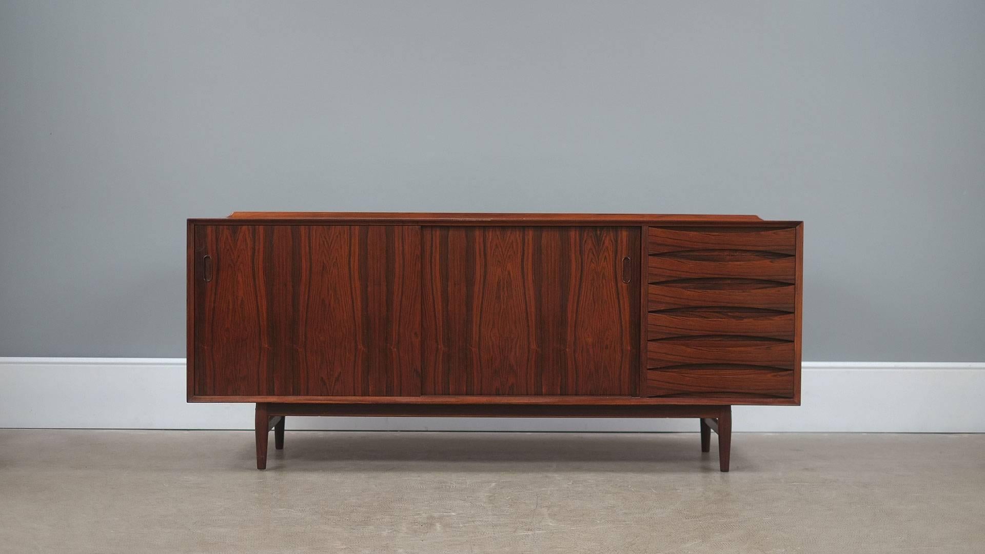 Beautiful low sideboard in rosewood with highly figured grain designed by Arne Vodder for Sibast, Denmark. Classic and sought after piece.