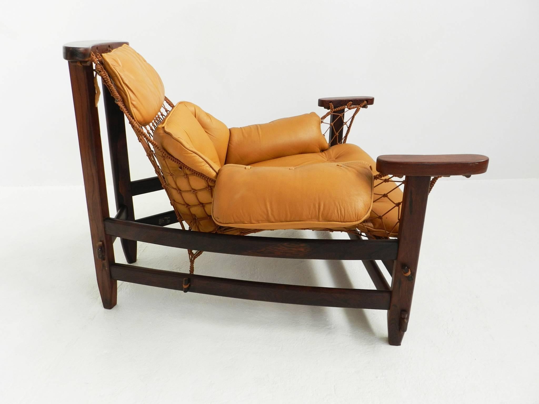 Iconic pair of Brazilian lounge chairs designed by Jean Gillon, in 1962 and produced by Italma Wood Art Industria Brasileira. 

Solid jacaranda frame, cord supports and loose cushion in cognac brown patinated leather.
 