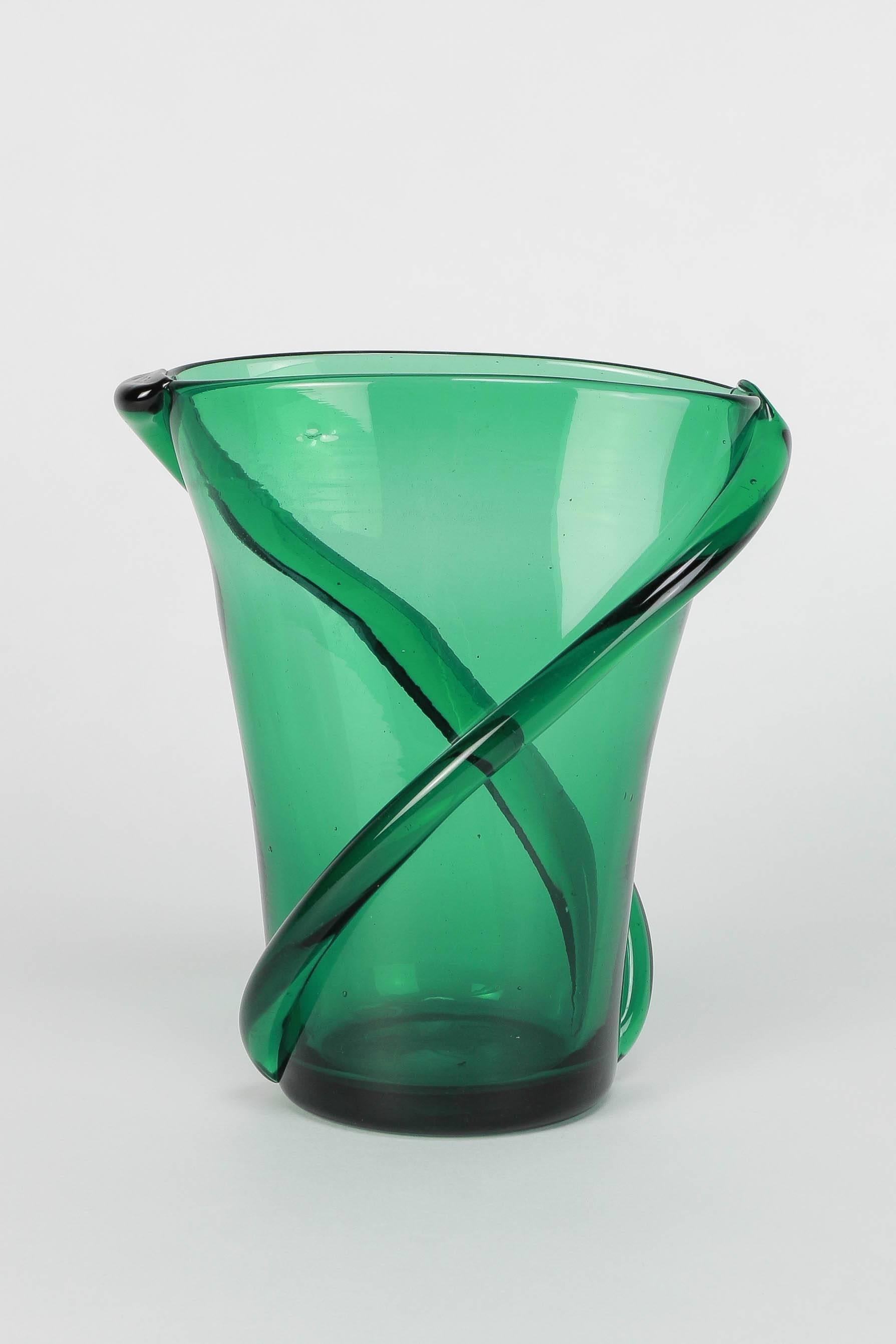 A gorgeous Italian glass vase manufactured in Empoli in Italy in the 1960s. Mouth-blown glass in a vibrant green color and wonderful twisted glass stripes. High-end craftsmanship, polished pontil mark on bottom.