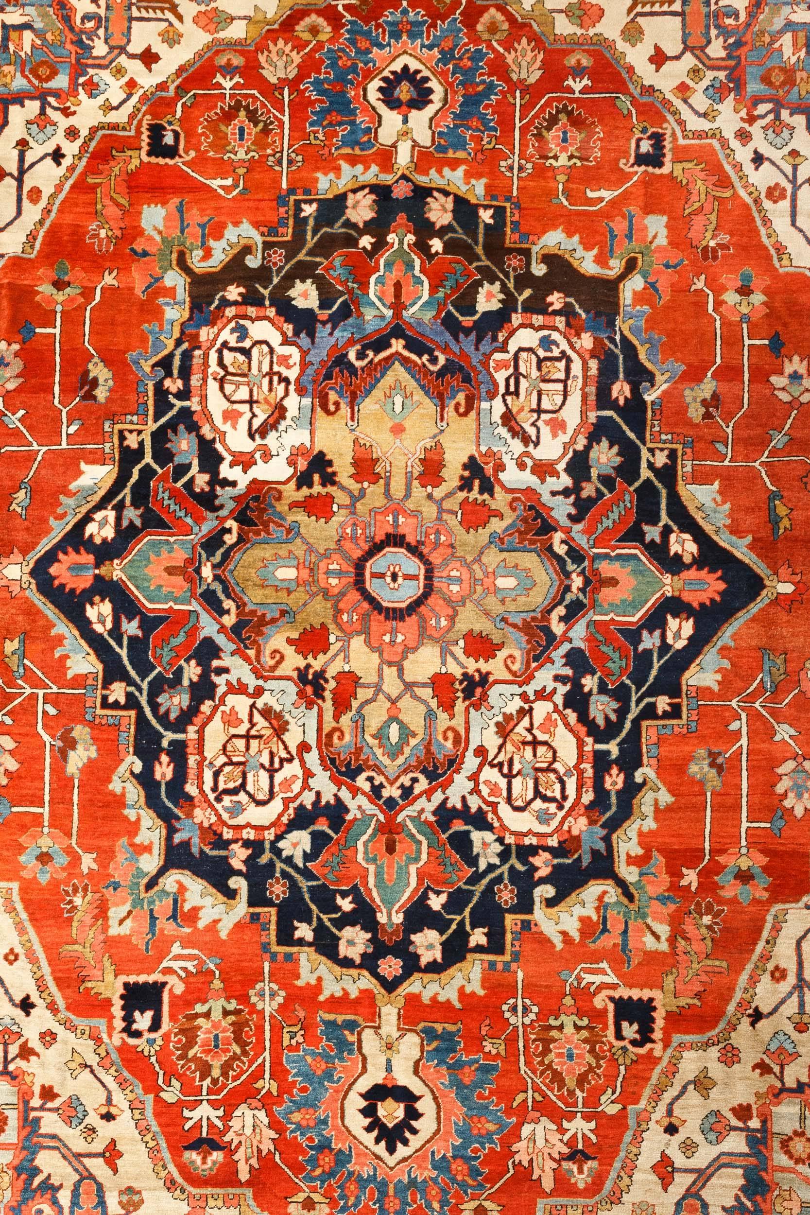 Sublime antique Persian Heriz Serapi rug, over 100 years old with an incredible combination of ornaments. 
This stunning rug is composed of a classical geometric and floral octofoil medallion in the center over a rich Vermillion colored field with