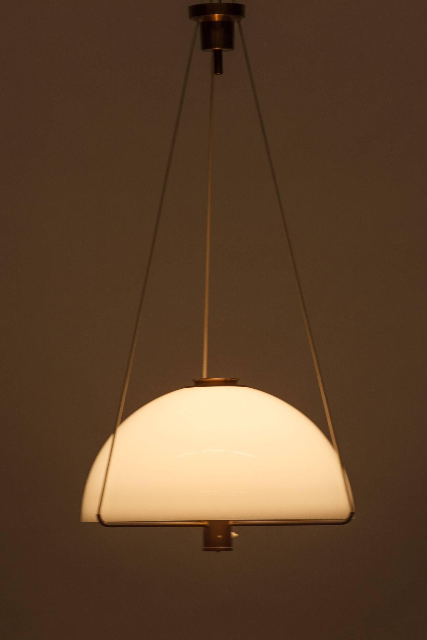 Rarely seen Anders Pehrson pendant, model 288 P made of brass and a acrylic glass shade, manufactured in the 1970s by Ateljé Lyktan (information about the designer, model and year were given by Ateljé Lyktan). The lamp can be adjusted in height;