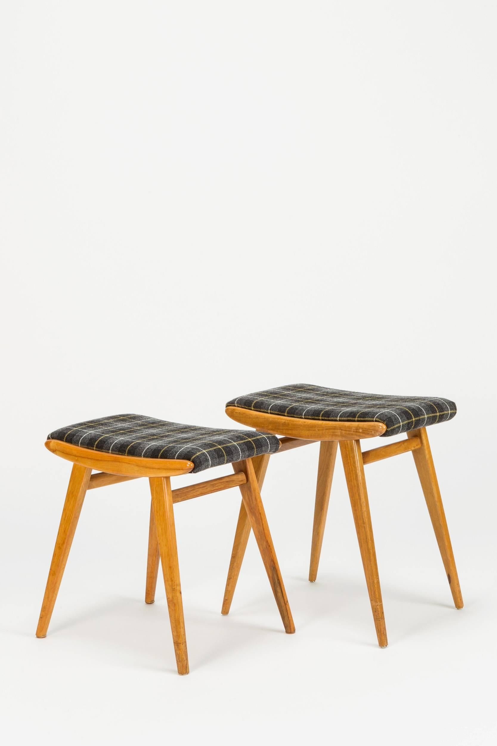Pair of solid walnut stools by Jens Risom for H.G. Knoll in Germany in the 1940s. They were new covered with a wonderful Scottish check fabric in wool.