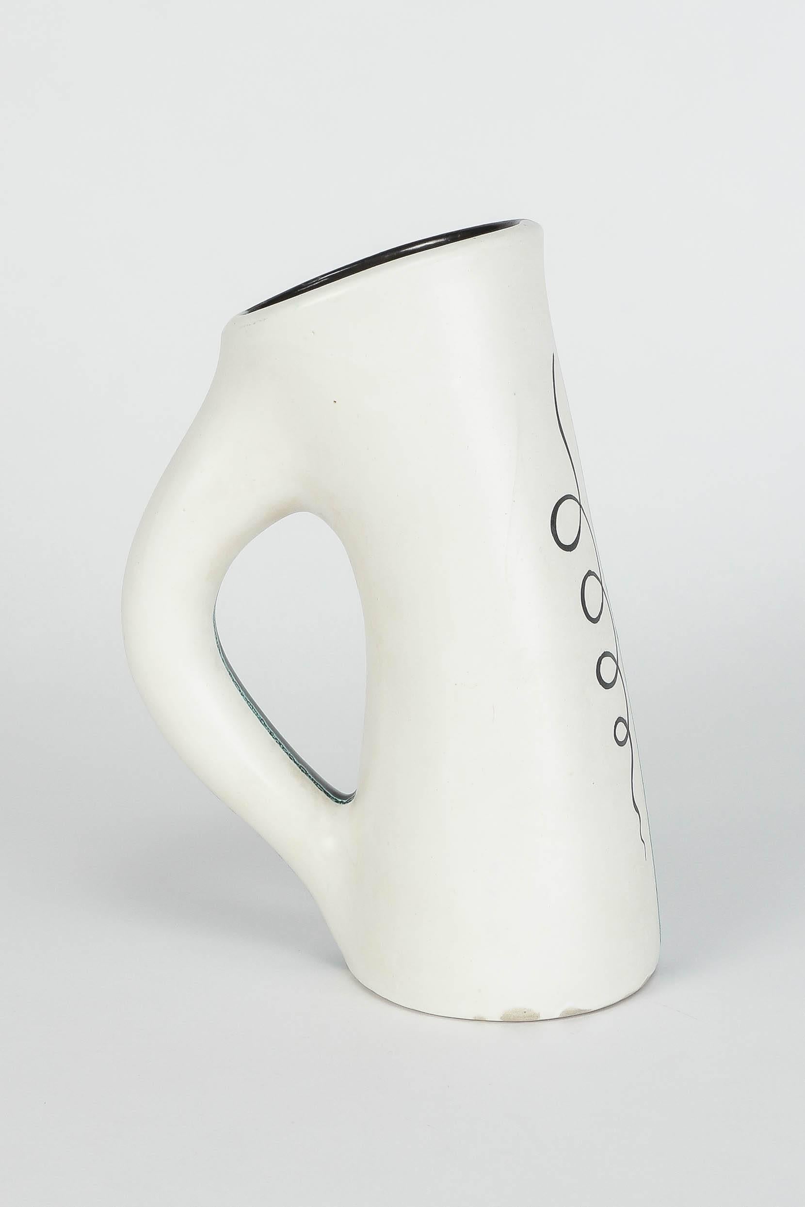 French pottery pitcher by Charles René Neveux for the renowned ceramic atelier Cerenne of Vallauris, manufactured in the 1950s. On one side white and black on the other, slightly blue in the middle. Signed to bottom with.