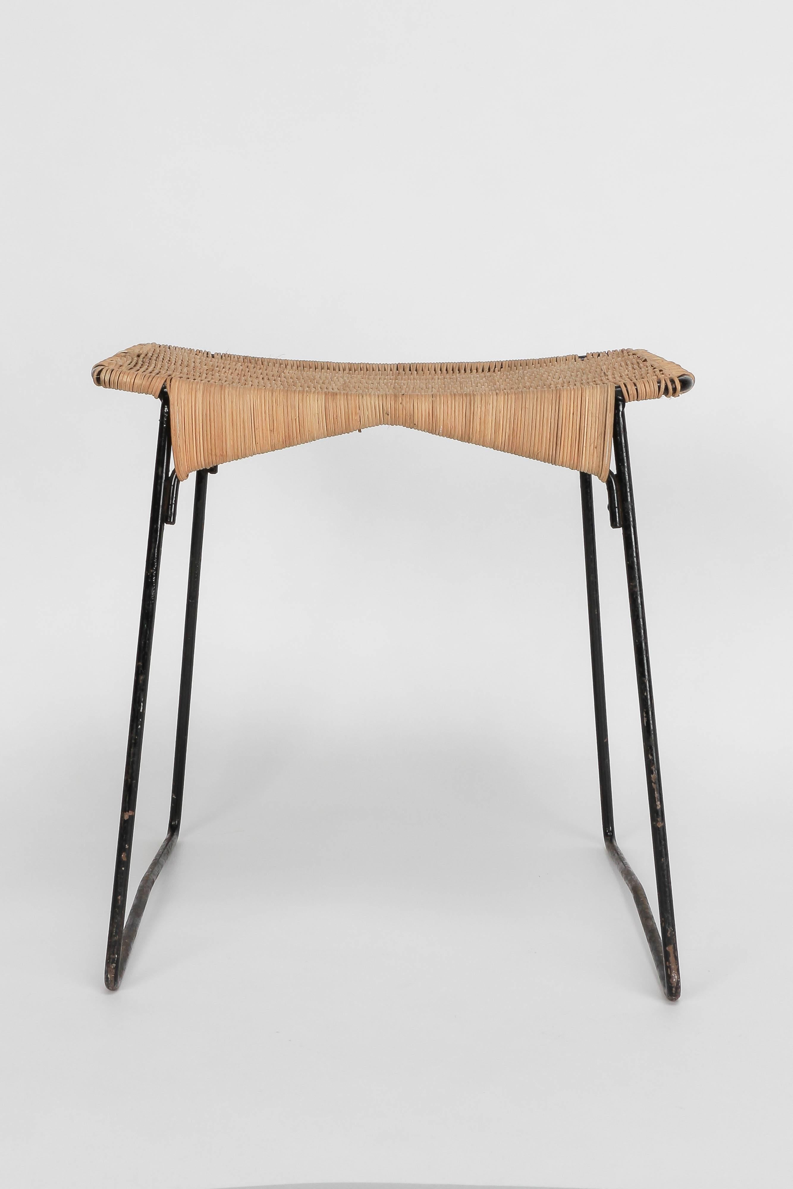 French wicker stool, manufactured in France in the 1950s. Fine black lacquered metal frame with a hand woven wicker seat. Very nicely crafted details.