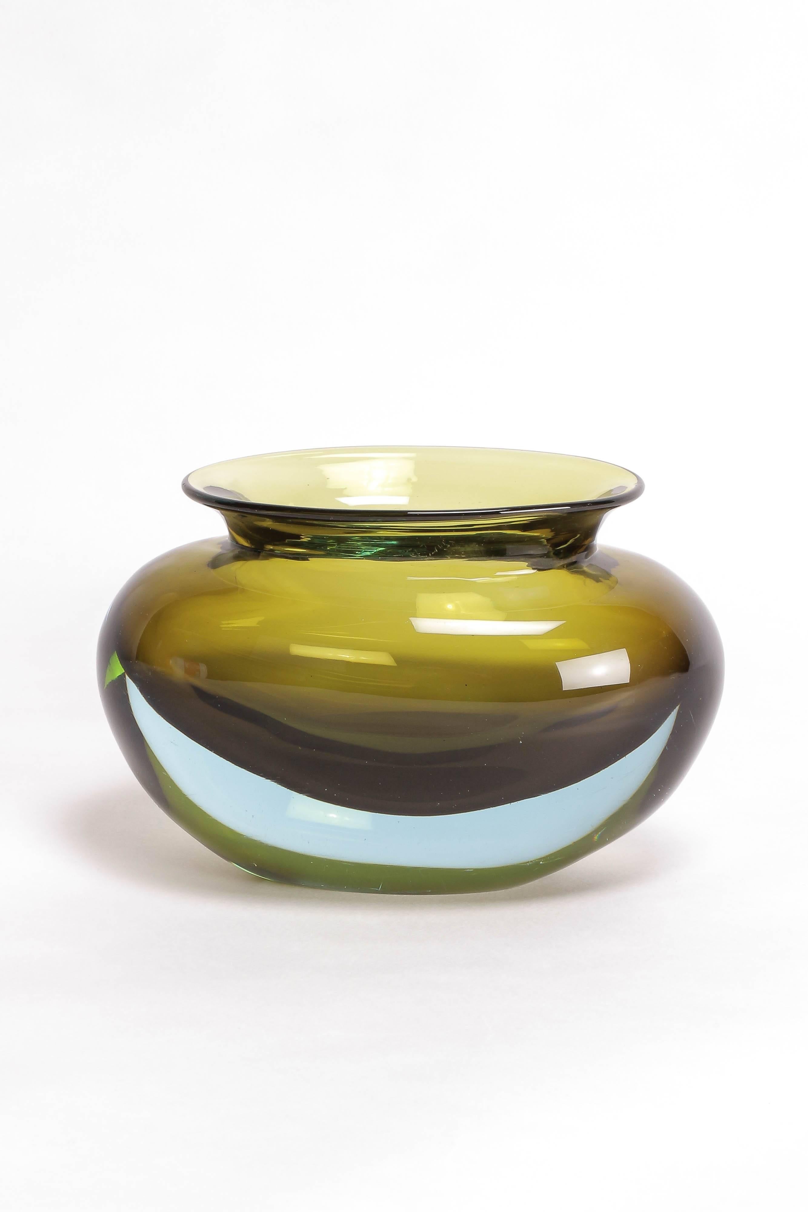 A stunning Murano vase by Flavio Poli, mouth-blown by the Seguso glass manufacture in 1963, color combination in "verde olive - acquamarina" a transparent olive green covered with transparent aquamarine, model number 12892. 

Literature: