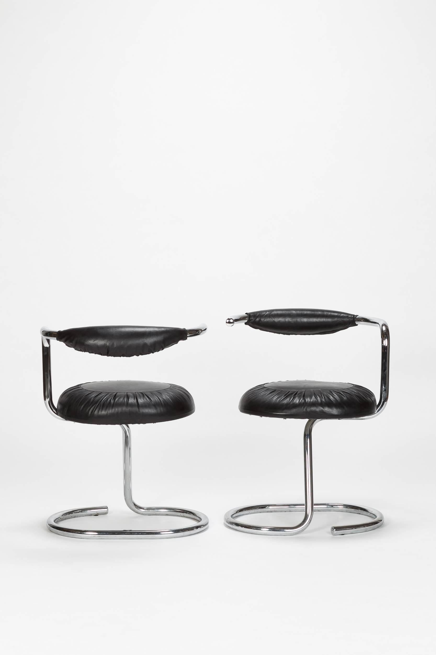 Pair of Giotto Stoppino Cobra chairs, manufactured in the 1970s. Characteristical tubular structure in stainless steel, winding from the base to the backrest. New cover in black goatskin.