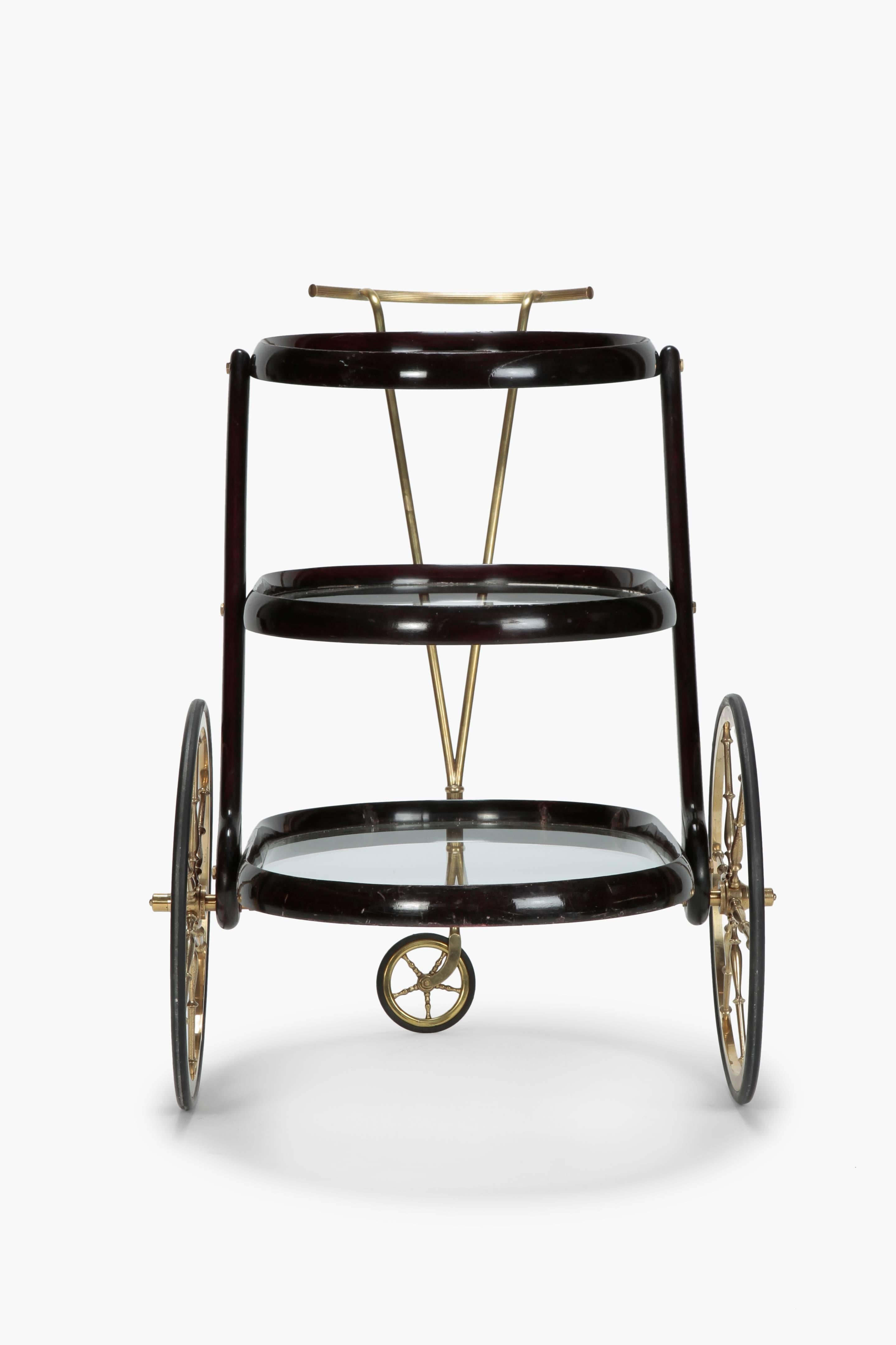 Cesare Lacca mahogany bar cart manufactured in Italy in the 1950s. Extraordinary nice work. Three shelves with glass trays, all metal parts made of solid brass. All parts original. Very elegant object.