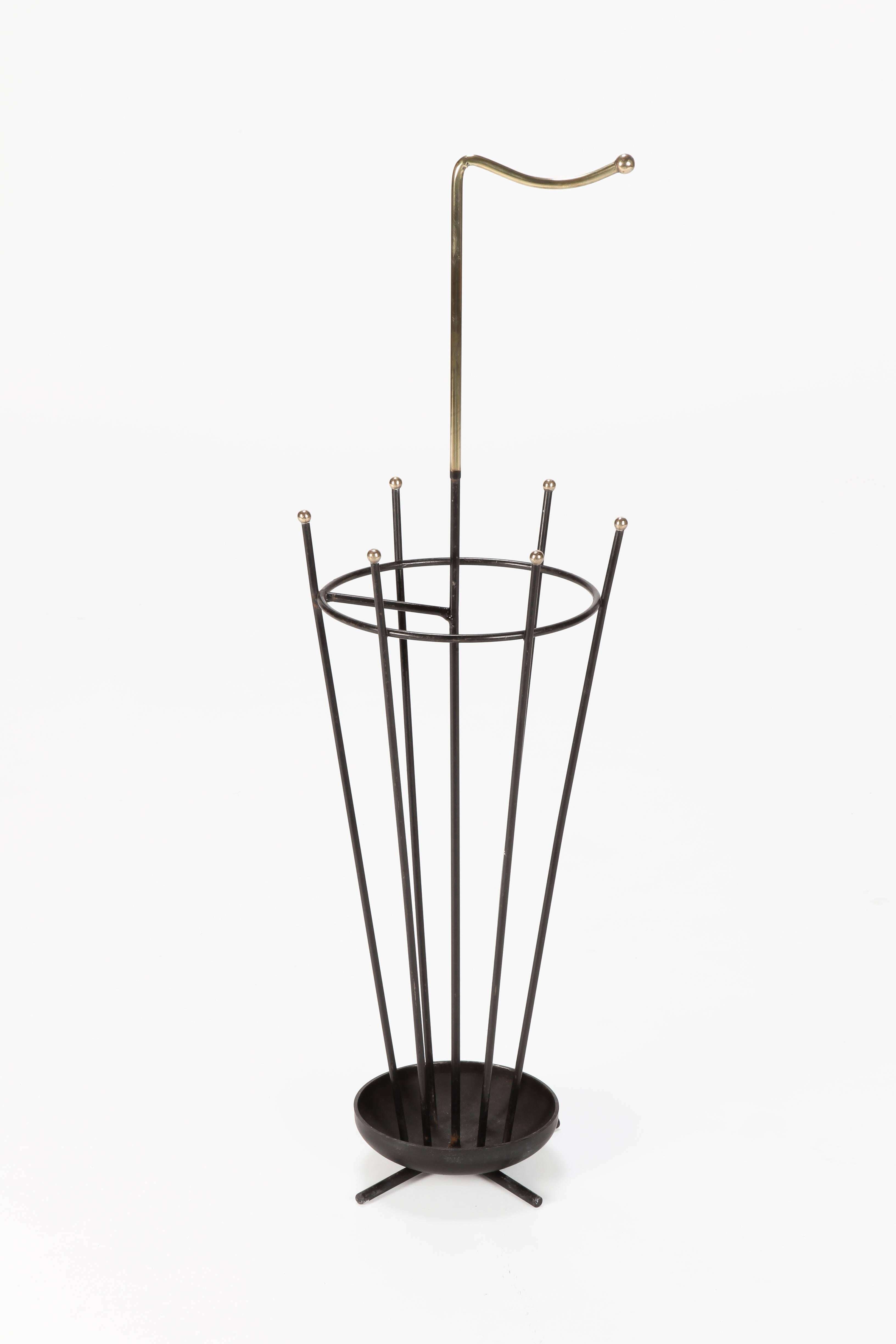 Umbrella stand in the style of Mathieu Mategot manufactured in France in the 1950’s. Black laquered metal and brass details.