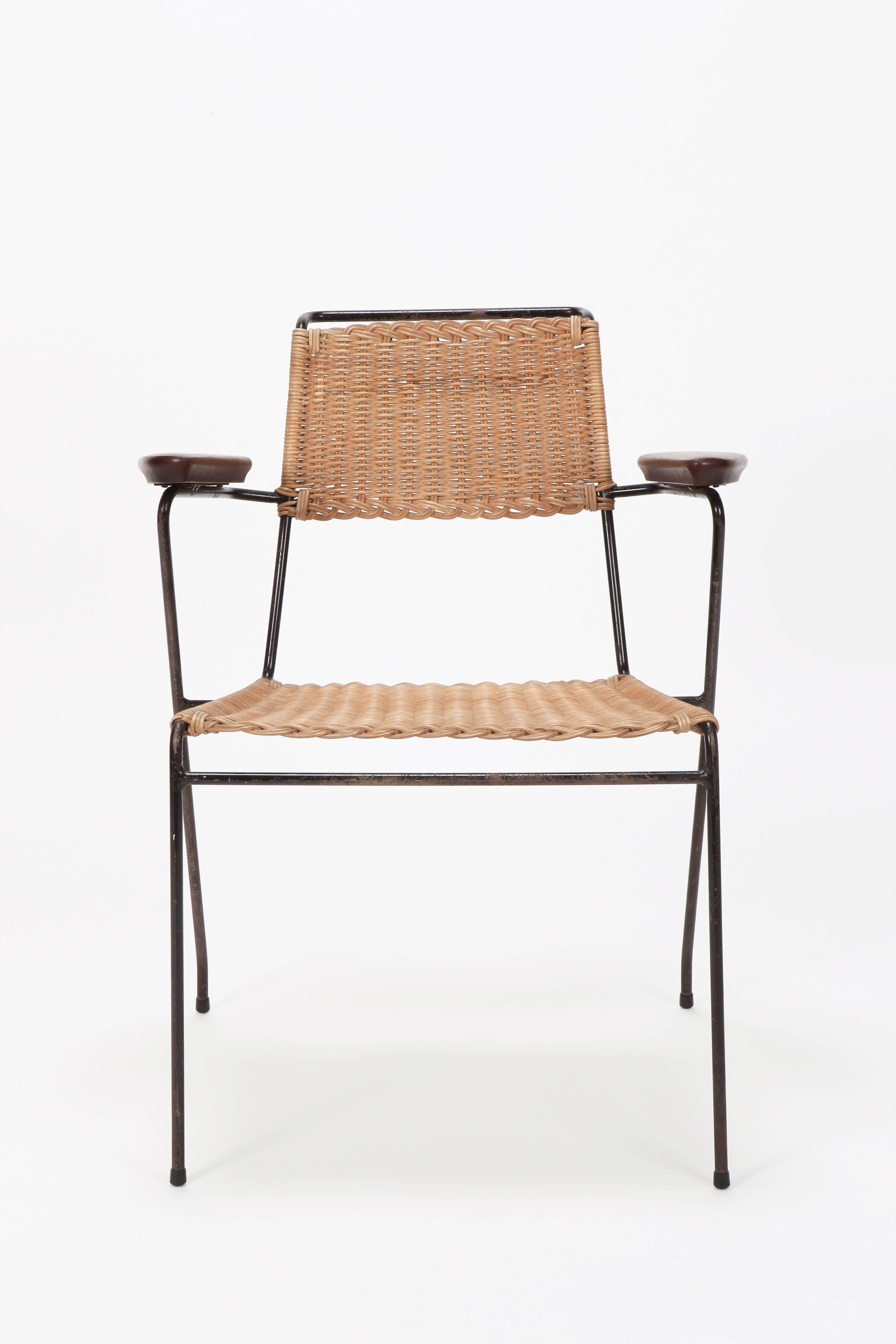 Paul Schneider von Esleben rattan chair manufactured by Wilde & Spieth in the 1950s. Solid teak armrests. The rattan is in very good condition and was recently restored. The black metal frame was just oiled and left with its beautiful original