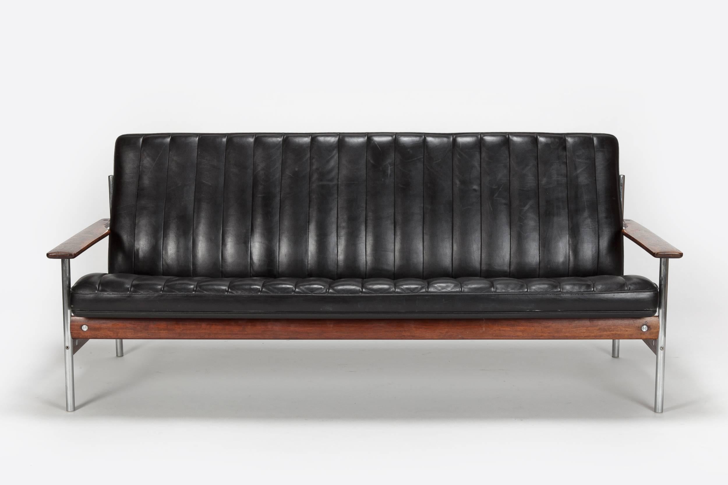 Stunning and very rare Sven Ivar Dysthe sofa from the 1959 designed “1001” series for Dokka Møbler in Norway. The frame is made of steel combined with beautiful grained solid rosewood, original black leather upholstery. All parts are of a distinctly