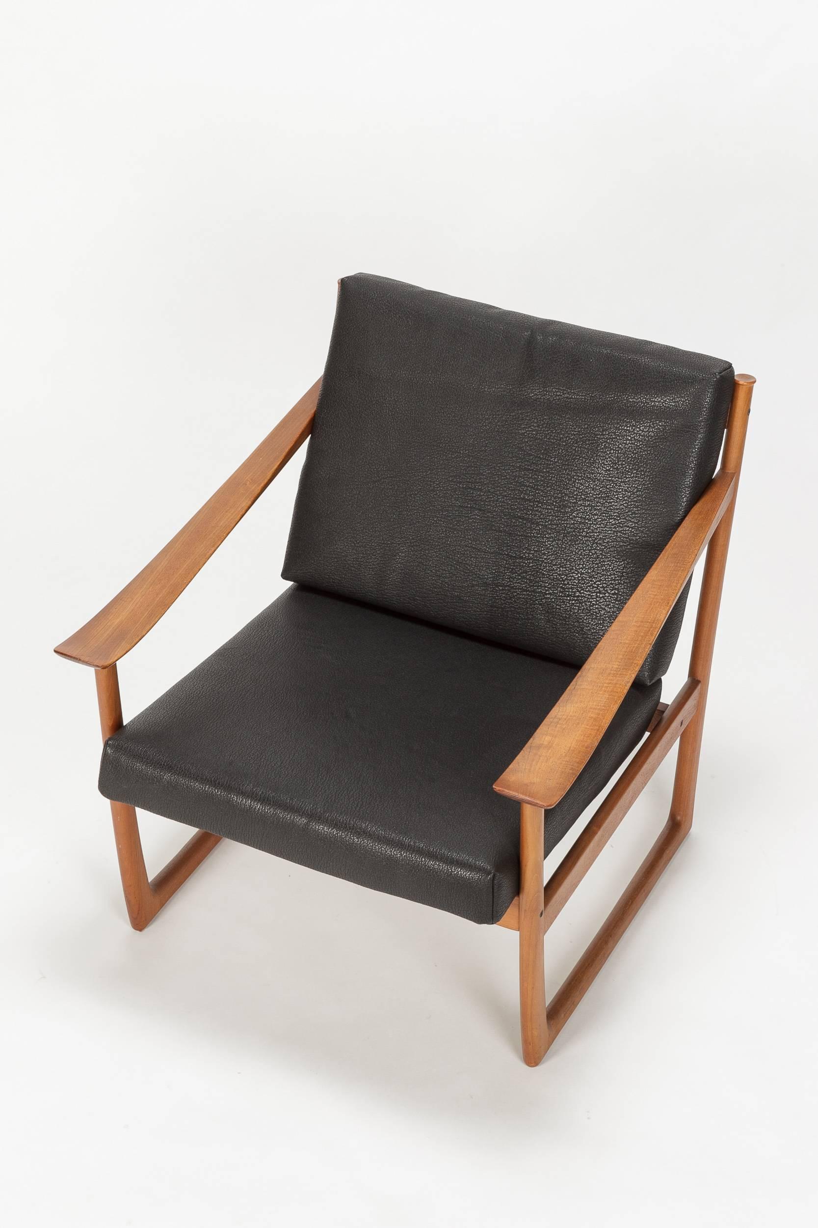 High-end pair of Peter Hvidt & Orla Mølgaard Nielsen lounge chairs model “Sled” or model number FD130, manufactured by France & Son in Denmark in the 1960s. Frame is made of solid teak with skids, very elegantly shaped armrests with wonderful