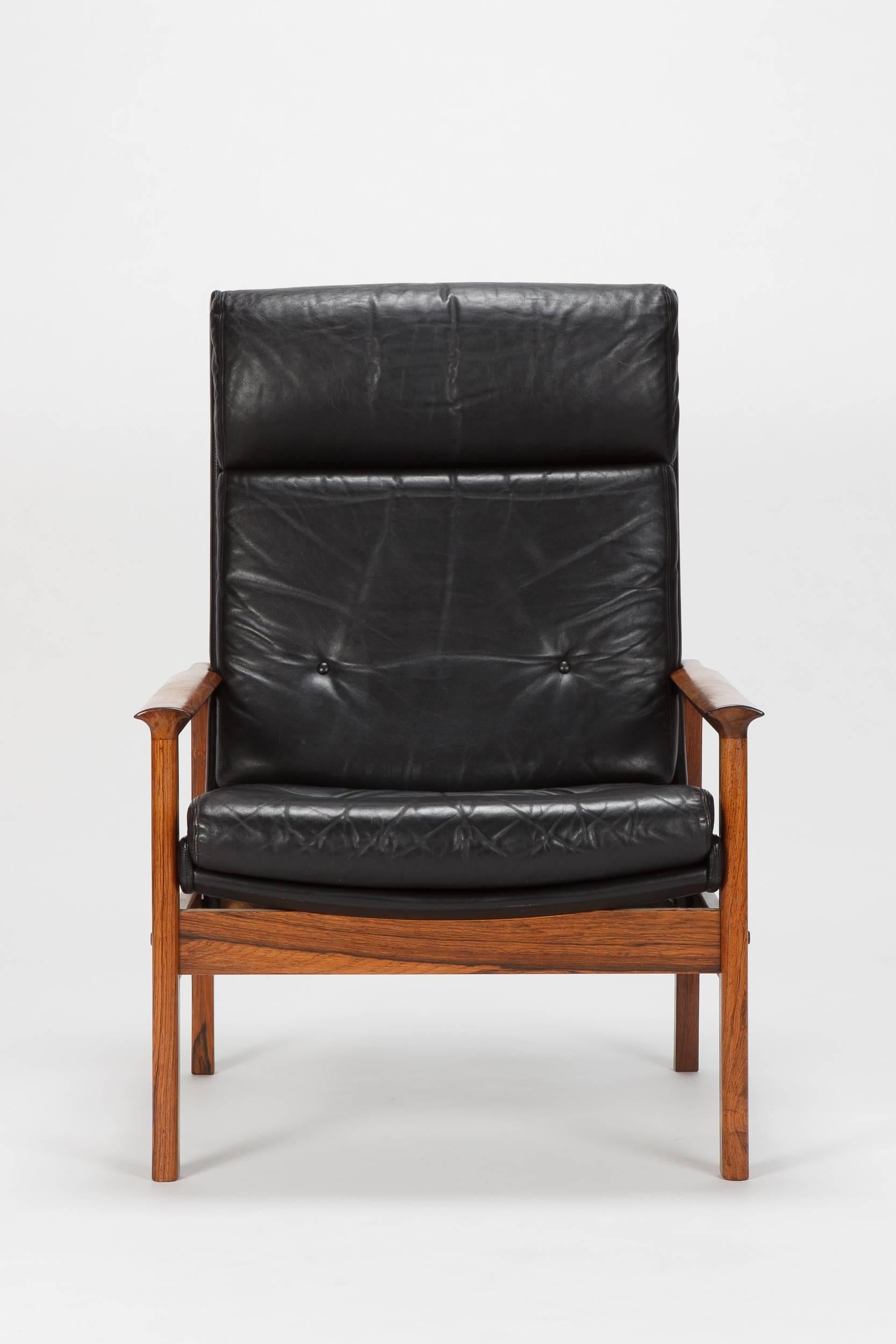 Beautiful rosewood high back lounge chair attributed to Frederik Kayser and manufactured in the late 1960s-early 1970s. Frame made of solid rosewood, beautiful vintage patina. Seat and back in gorgeous black leather. In a leather frame lined