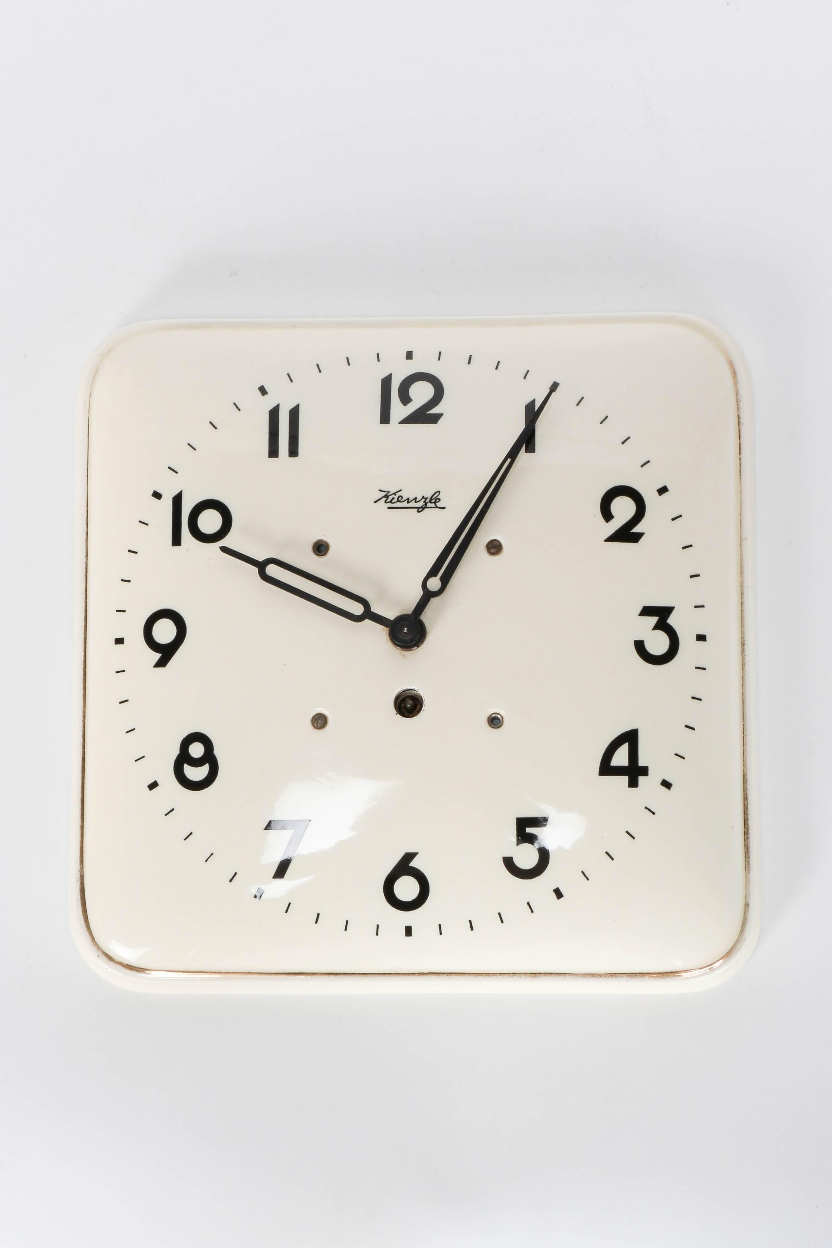 German wall clock manufactured by Kienzle in the 1930s. Body made of ceramic, with original mechanical movement. Original vintage condition, beautiful patina.
 