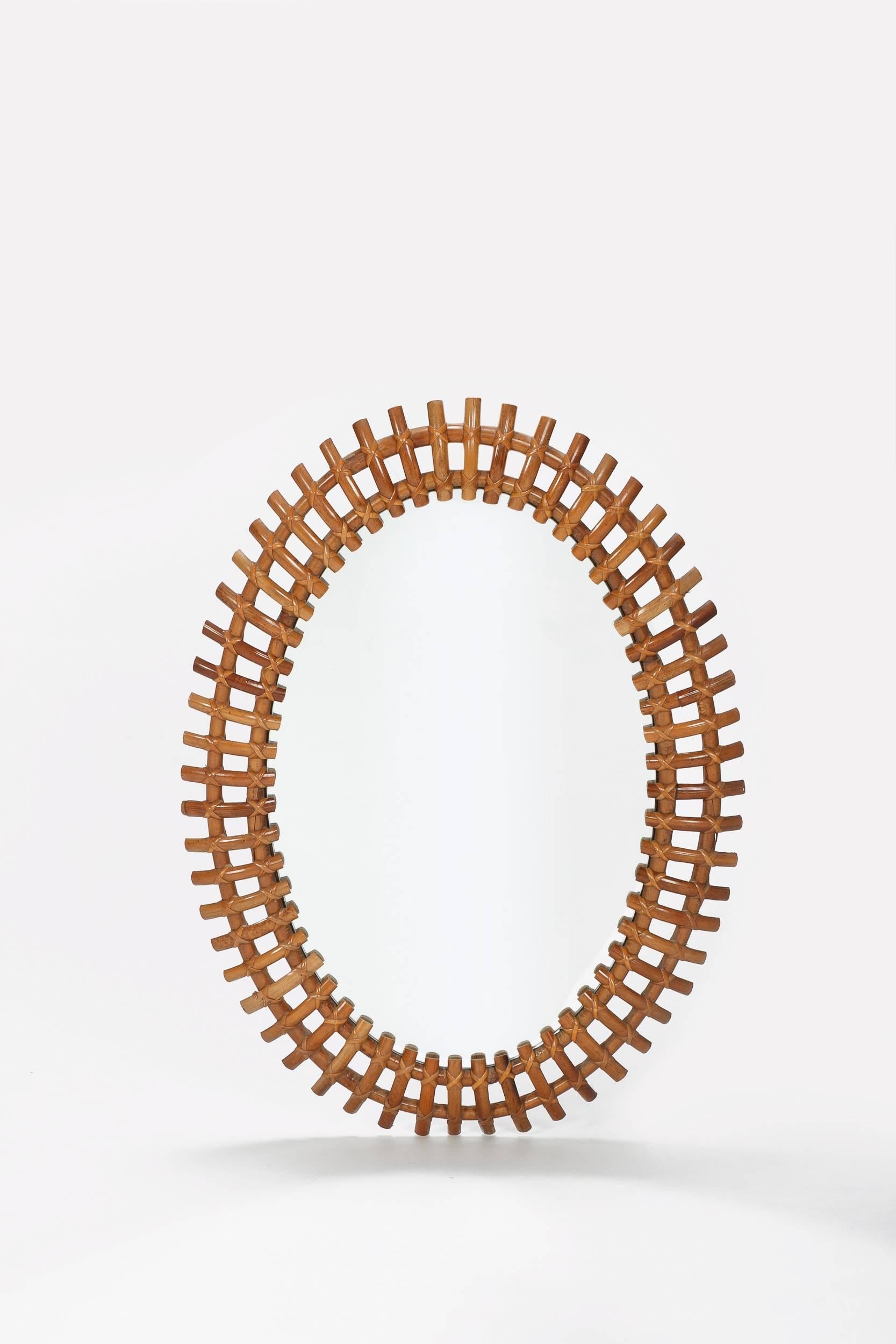 Large Italian bamboo sunburst mirror, manufactured in the 1950s. High-end craftsmanship, original mirrored glass, oval shape.