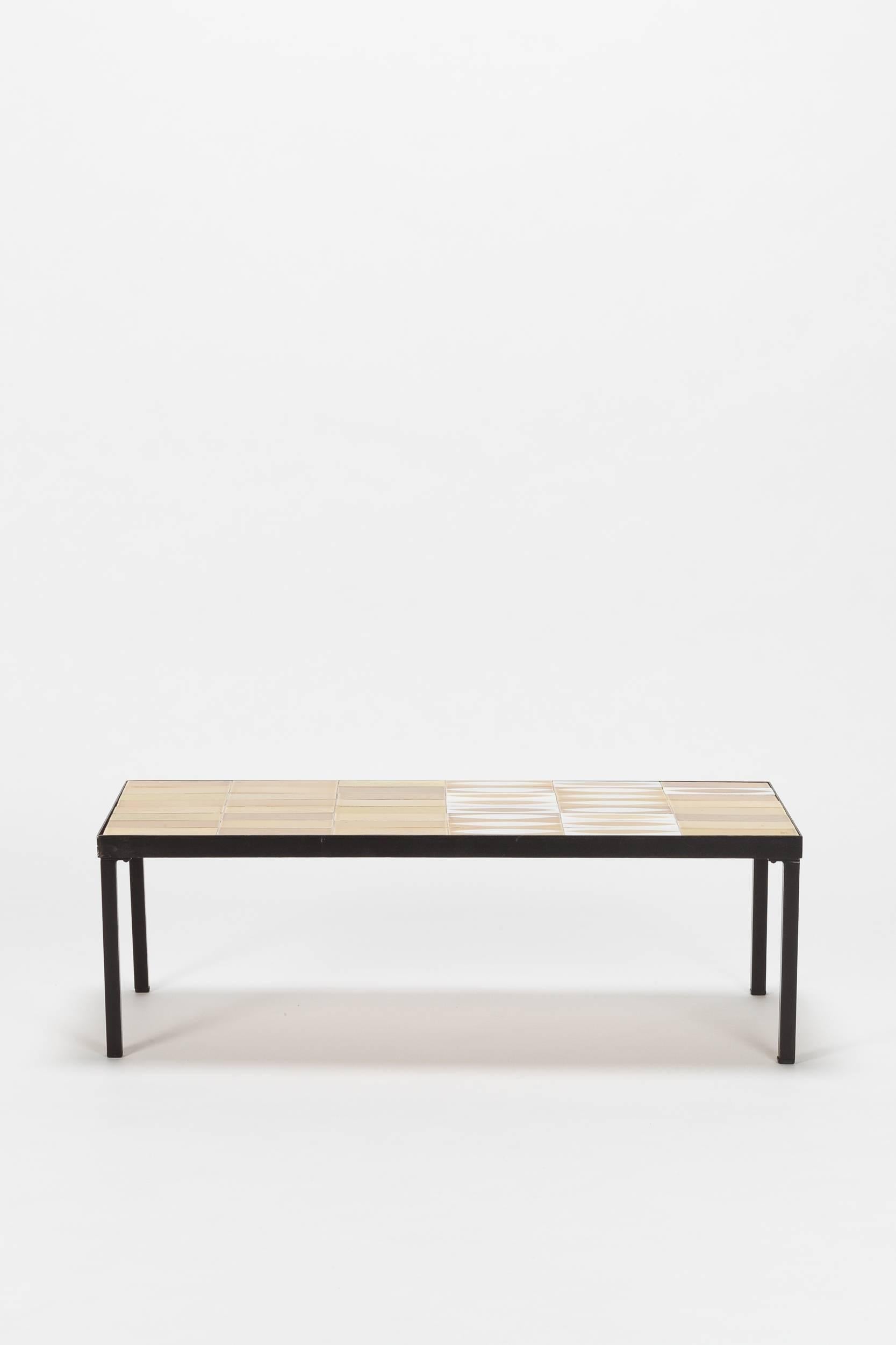 Roger Capron coffee table Navette designed in the 1950s and produced in France by Vallauris. The tabletop is made of ceramic tiles in extraordinary golden color hues and mounted on a black enameled metal frame.