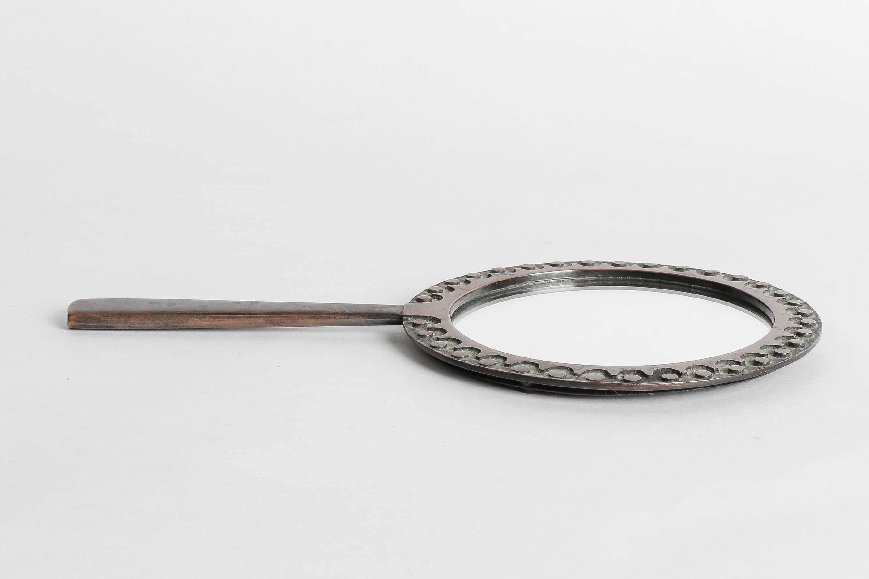 Hand-forged unique piece by the Hungarian sculptor Ottó Kopcsányi in the 1960s. Hand mirror made of bronze with a lovely pattern, hand-signed by the artist.