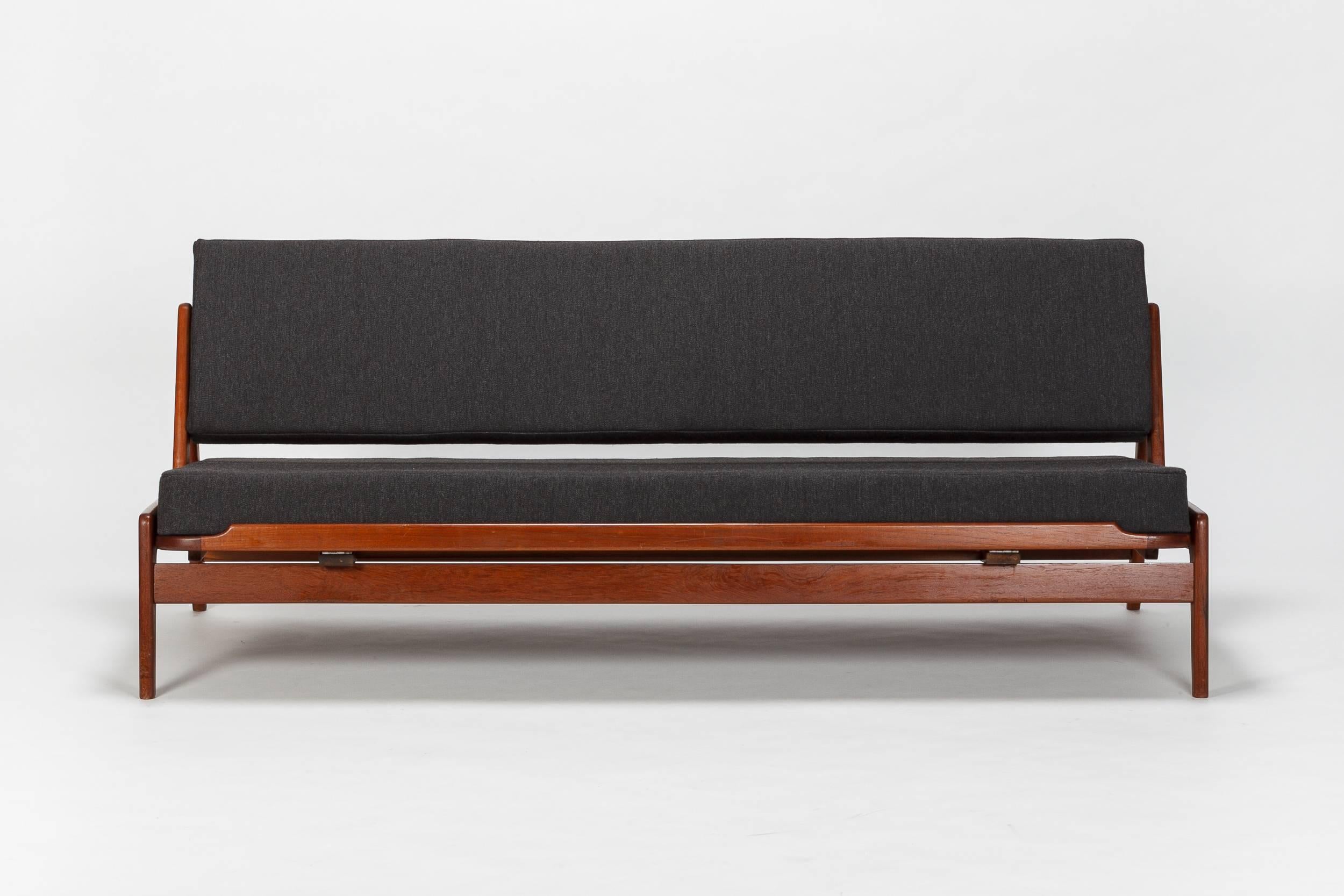 Arne Wahl Iversen sofa manufactured by Komfort in the 1950s. Functionality is the main theme with this piece. It can be simply used as a sofa, or roll out for a comfortable bed. Lovely piece, completely refurbished with new upholstery, anthracit