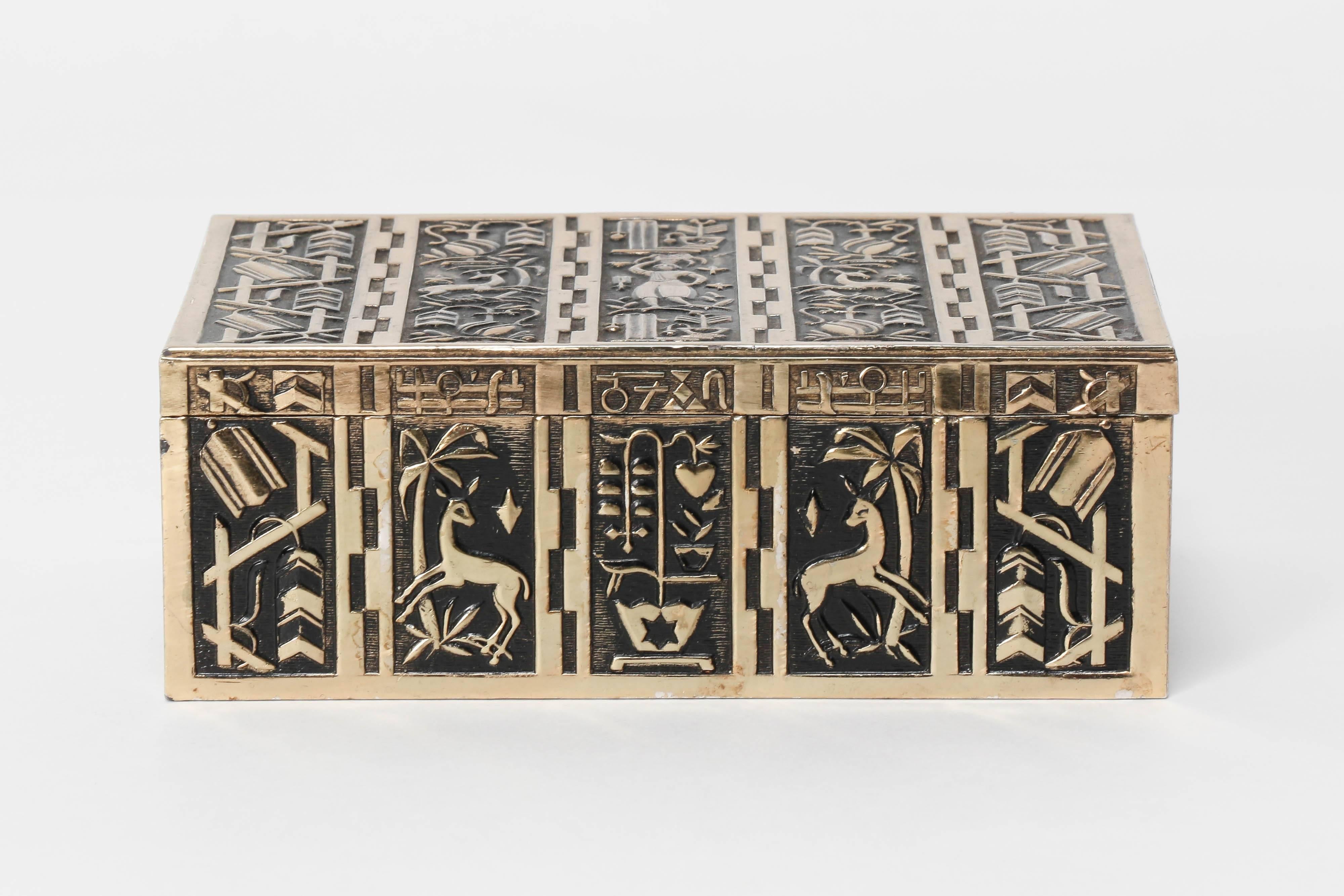 An Eugen Schwemmle cigarette box manufactured by Erhart Söhne in the 1930s in Germany. Made of brass, with a wooden inlay bottom. A square angled box with a brass hinge in the back and a wooden inlay. The German architect designed this object with