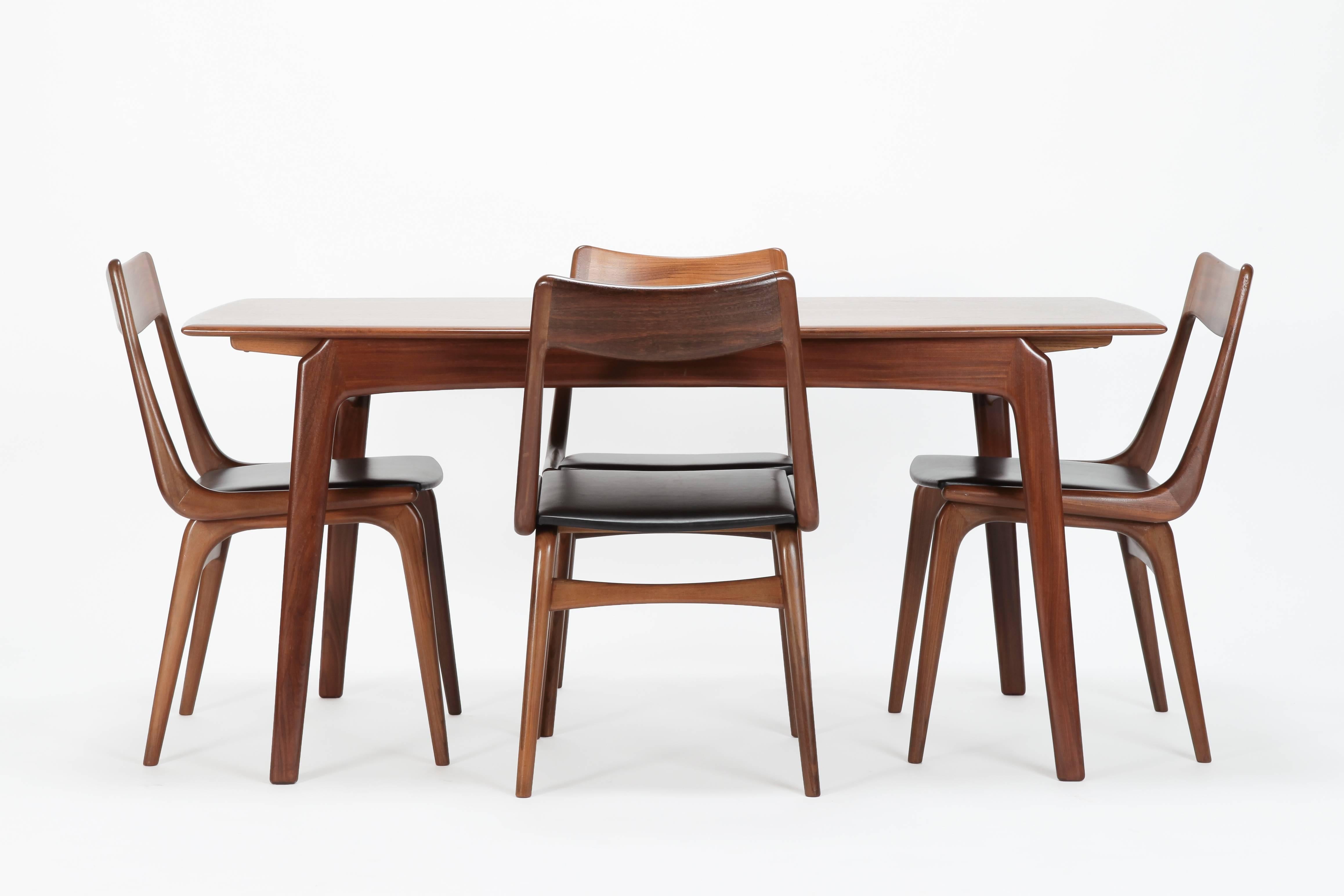 Erik Christensen dining table set manufactured in Denmark by Slagelse Mobelvaerk in the 1950’s. This table has one of the simplest and most elegant leaf storage designs. Hence to the legs of the table and the chair backrests, these popular design