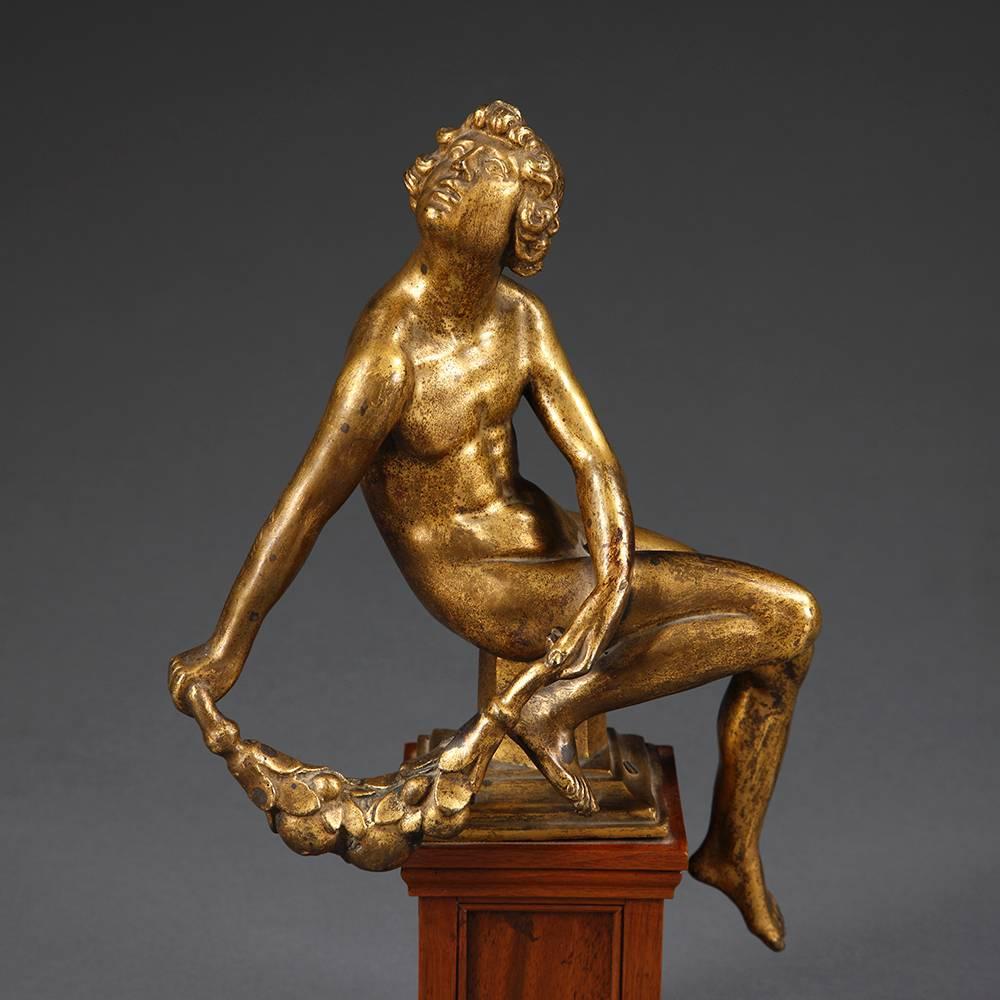 Each on an integrally cast pedestal and plinth, and with the remains of a fig leaf.
Some wear to gilding; minor damage to the garland of one figure.

German, circa 1690.
This set of bronzes must originally have adorned a larger ensemble,