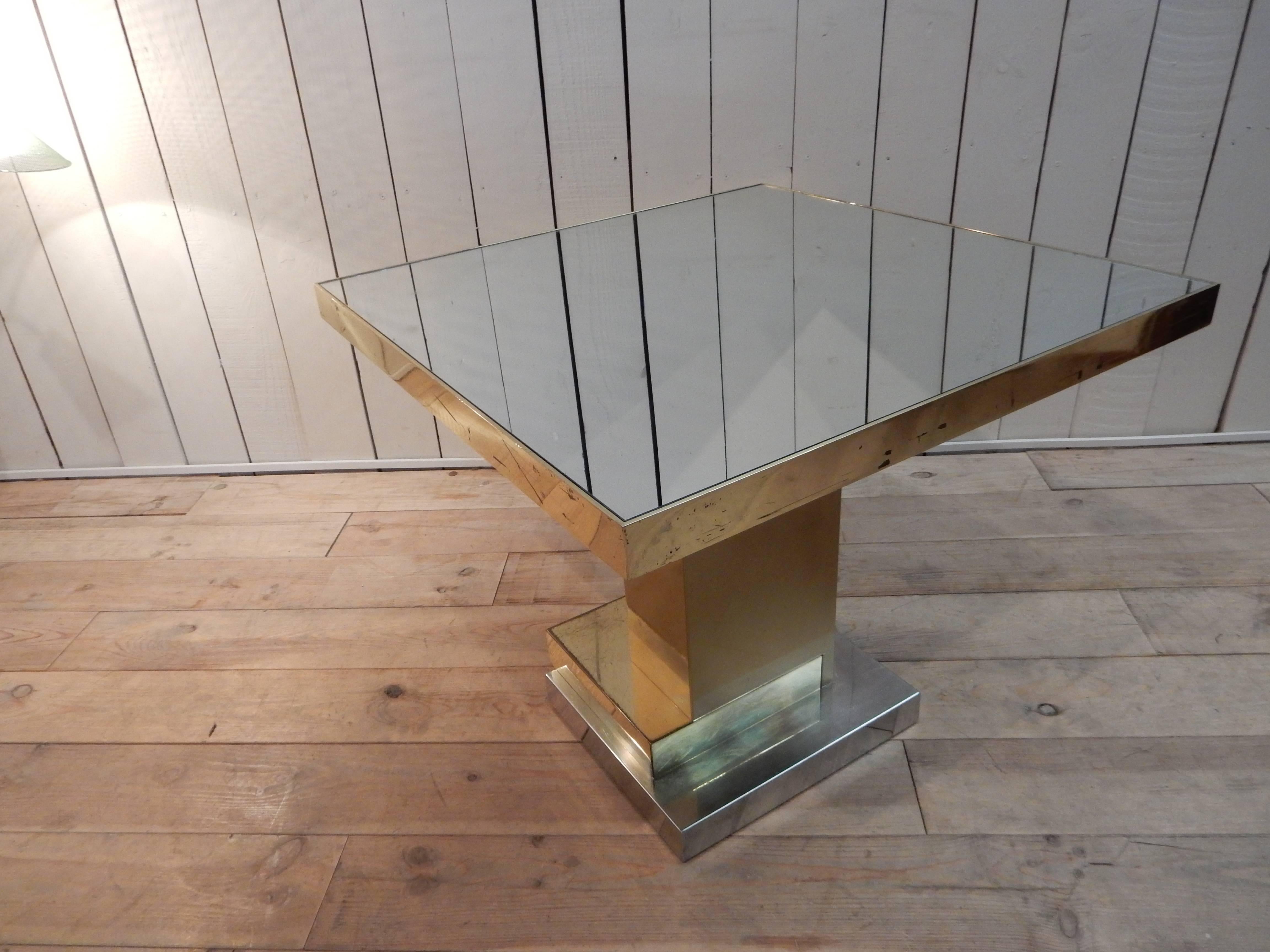 A very nice and decorative table made of brass, steel and glass, circa 1970.