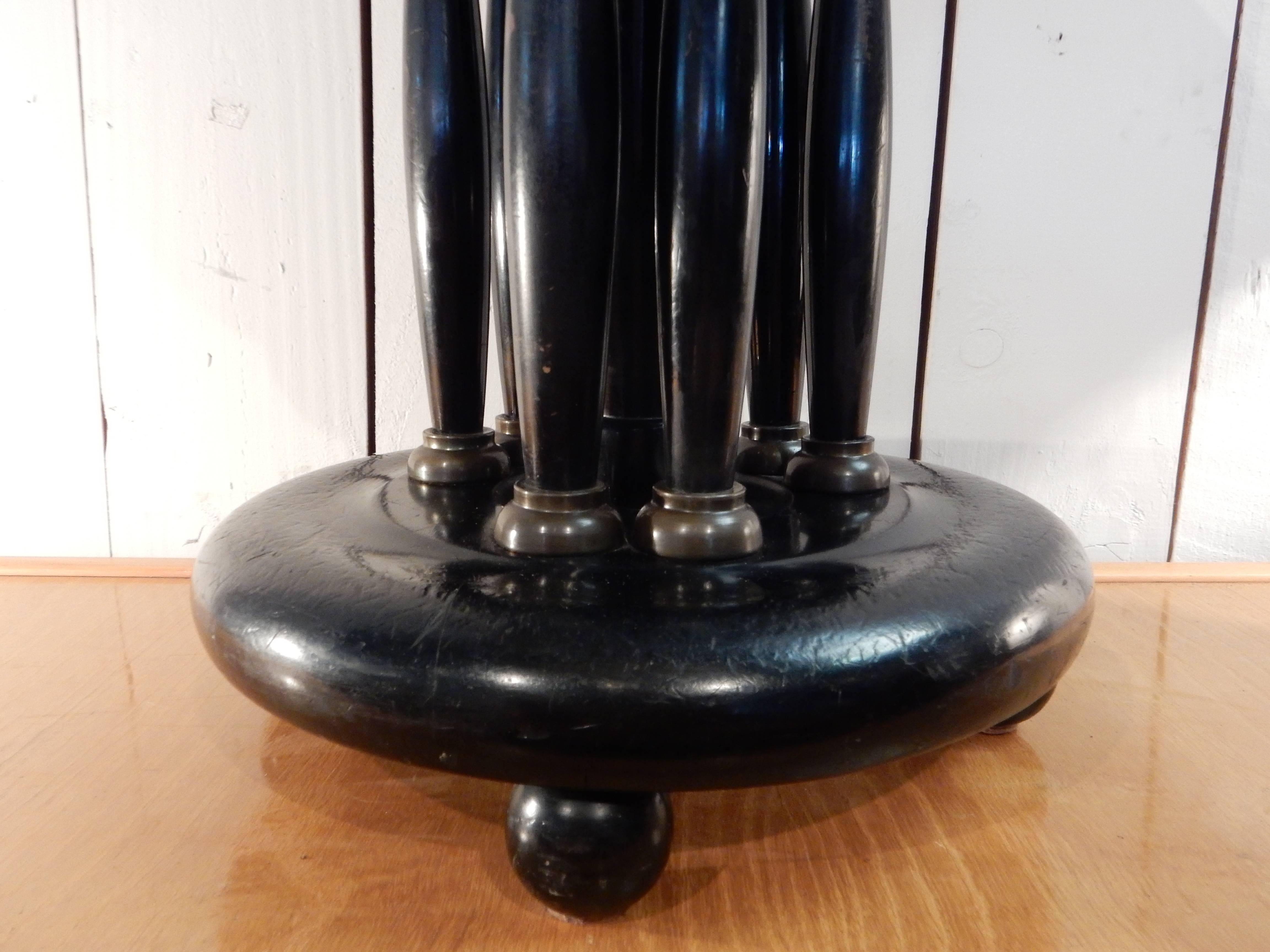 A very nice Art Deco black lacquered wood stool with leather top circled by oak and brass base.