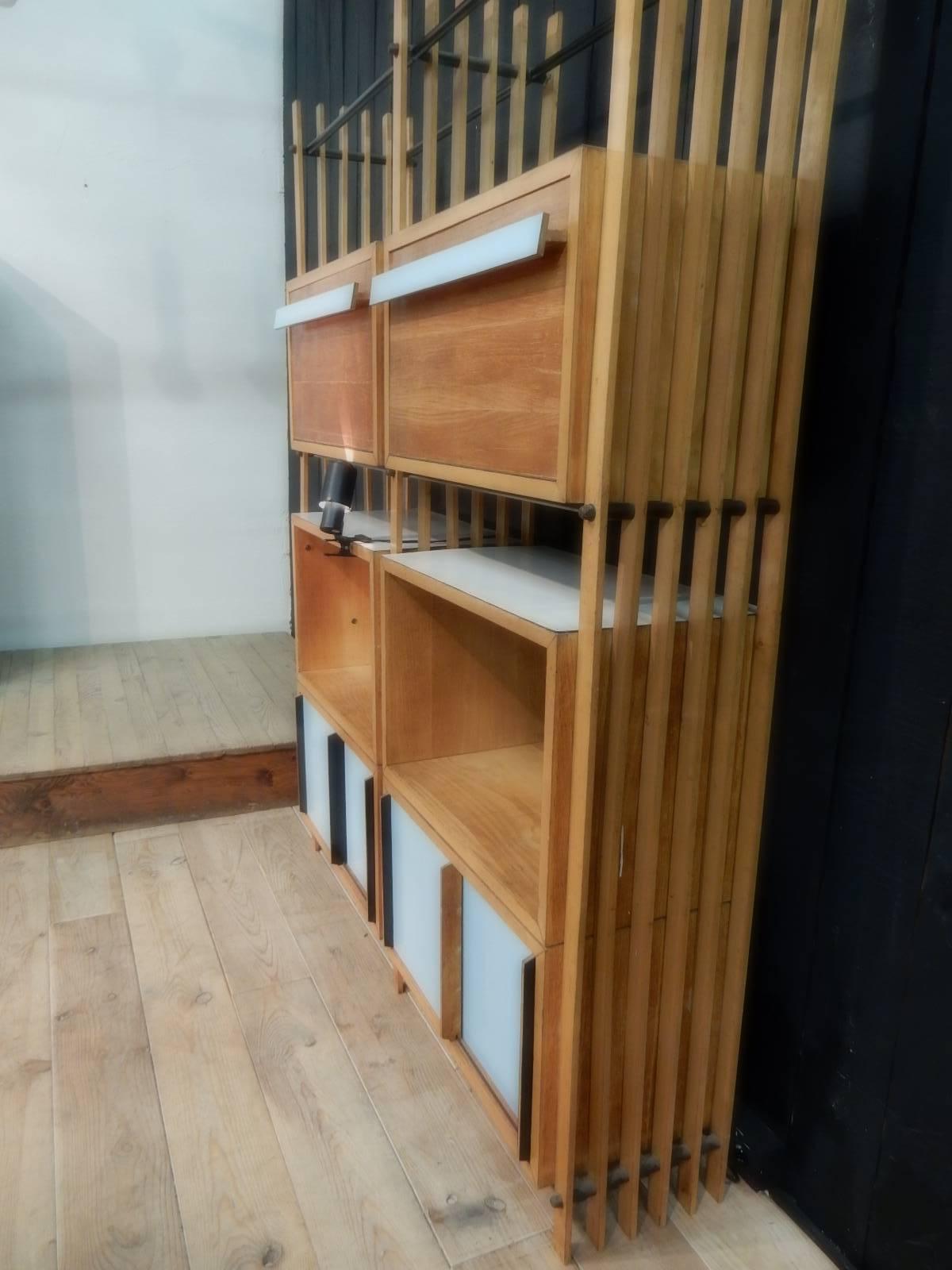 An 1950 Italian bookshelves made of sycamore and original blue laminated wood.