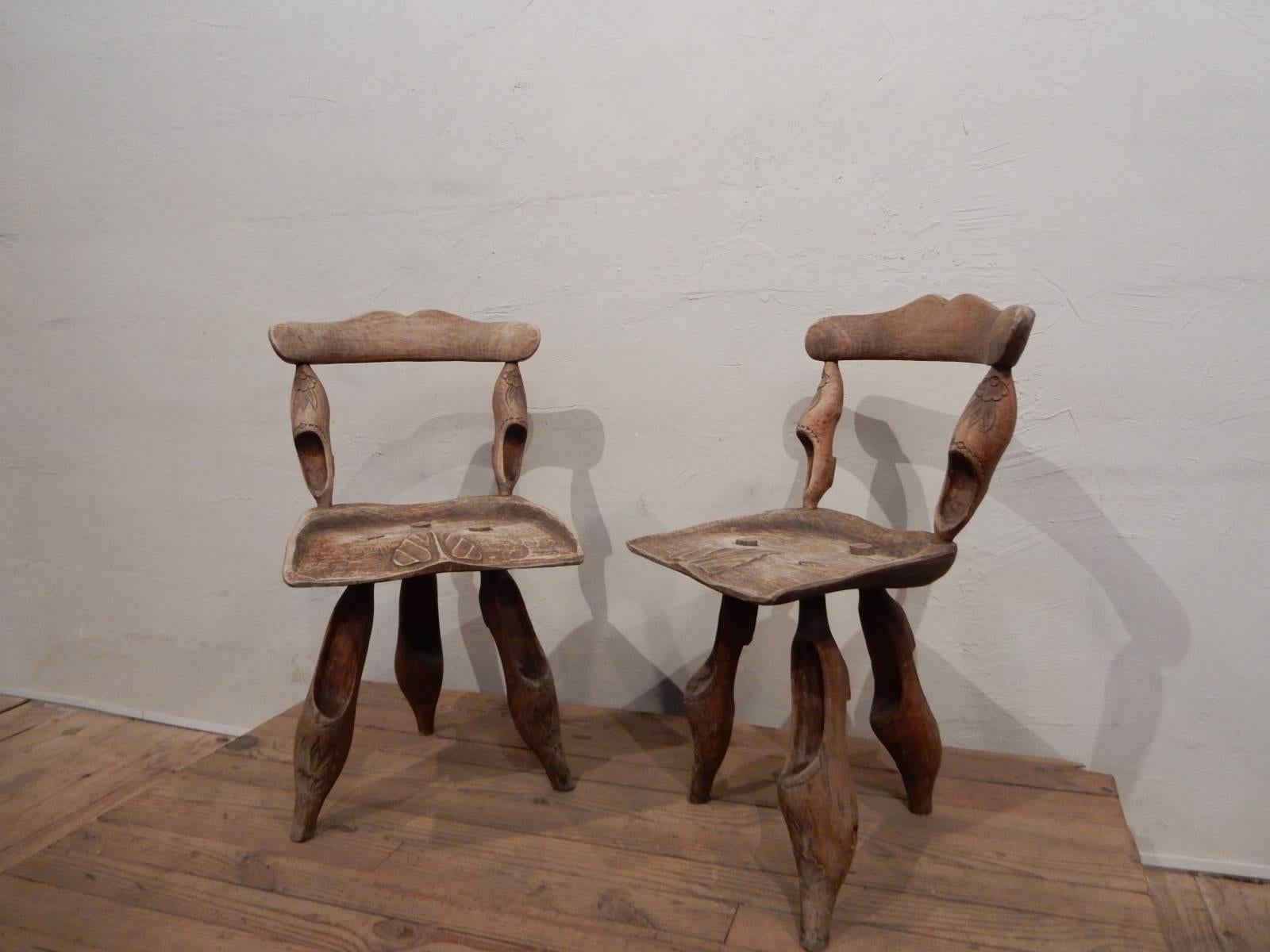 A pair of art populaire chair in massive wood respresenting 
