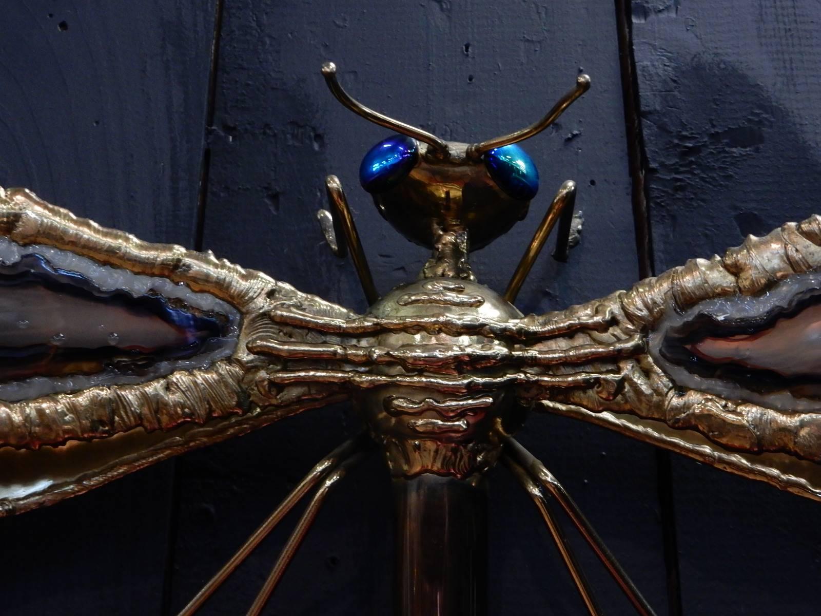 A beautiful dragonfly sconce by Jacques Duval Brasseur made of golden brass and agate in very good condition.