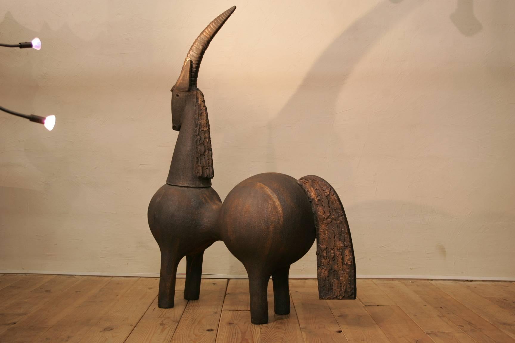 A tall sculpture by the ceramist Dominique Pouchain made of 